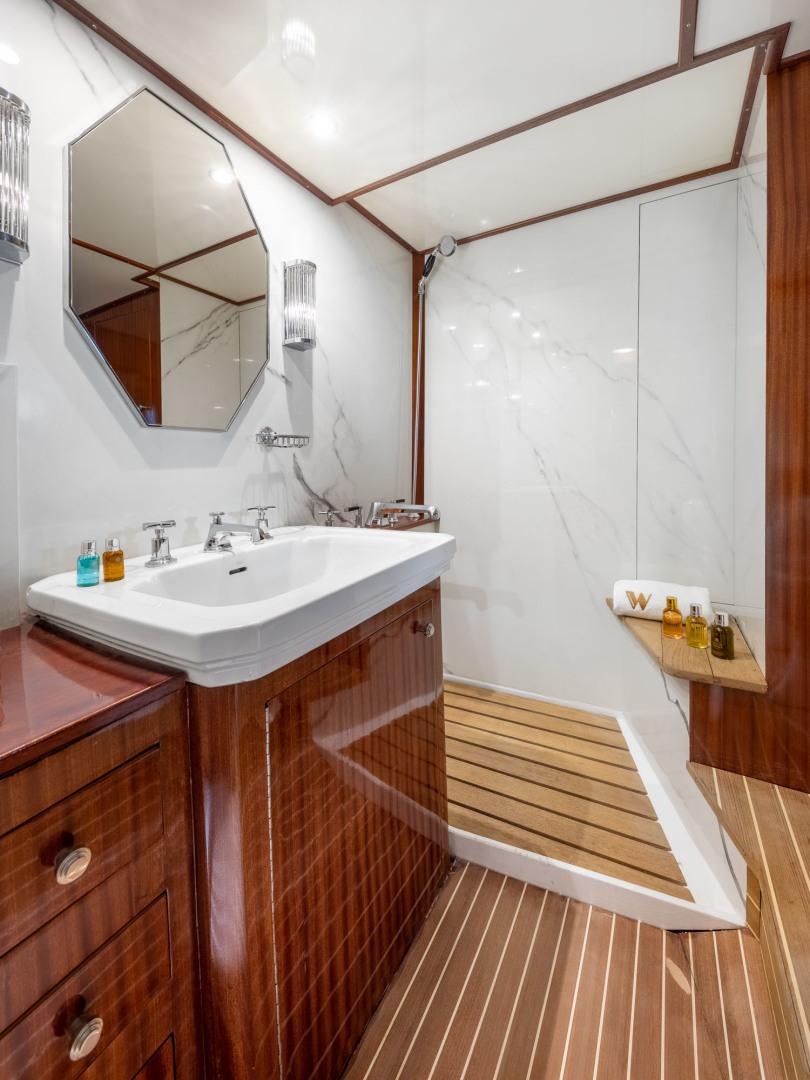 a bathroom with a sink and a mirror aboard WEATHERBIRD Yacht for Sale