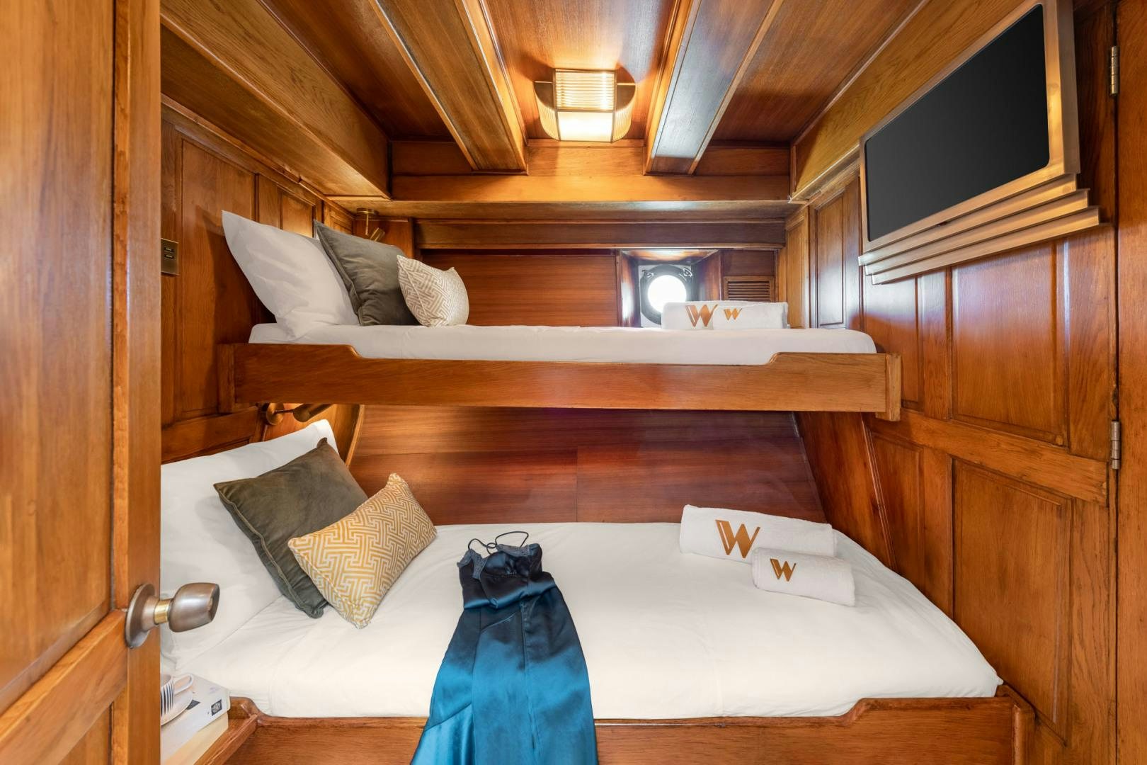 a bed with a blue blanket aboard WEATHERBIRD Yacht for Sale