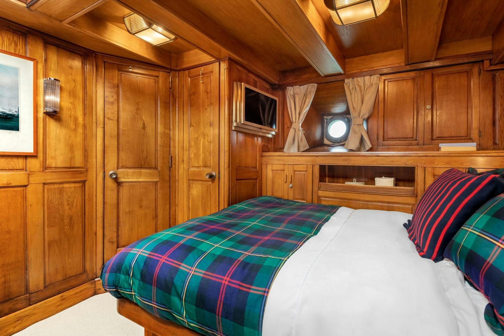 a room with a bed and a cupboard aboard WEATHERBIRD Yacht for Sale