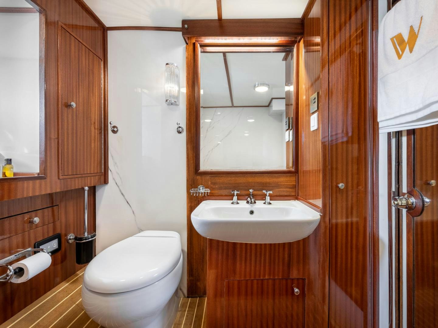 a bathroom with a toilet and sink aboard WEATHERBIRD Yacht for Sale