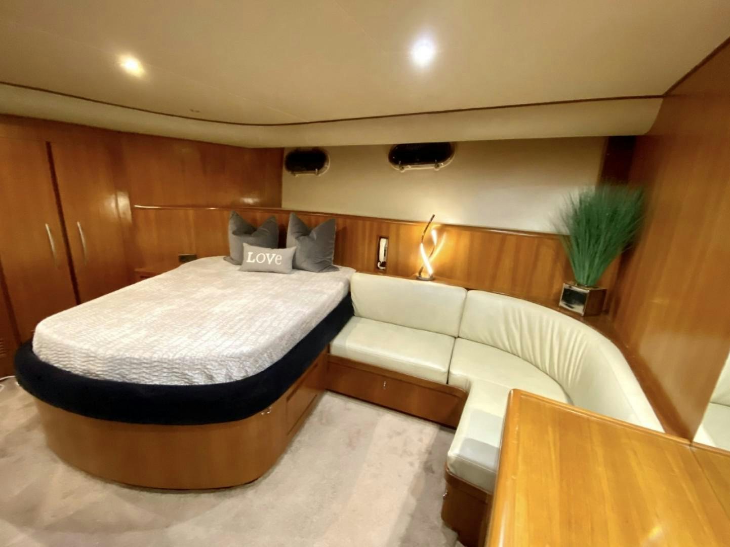 a room with a bed and a plant aboard Applaus Yacht for Sale