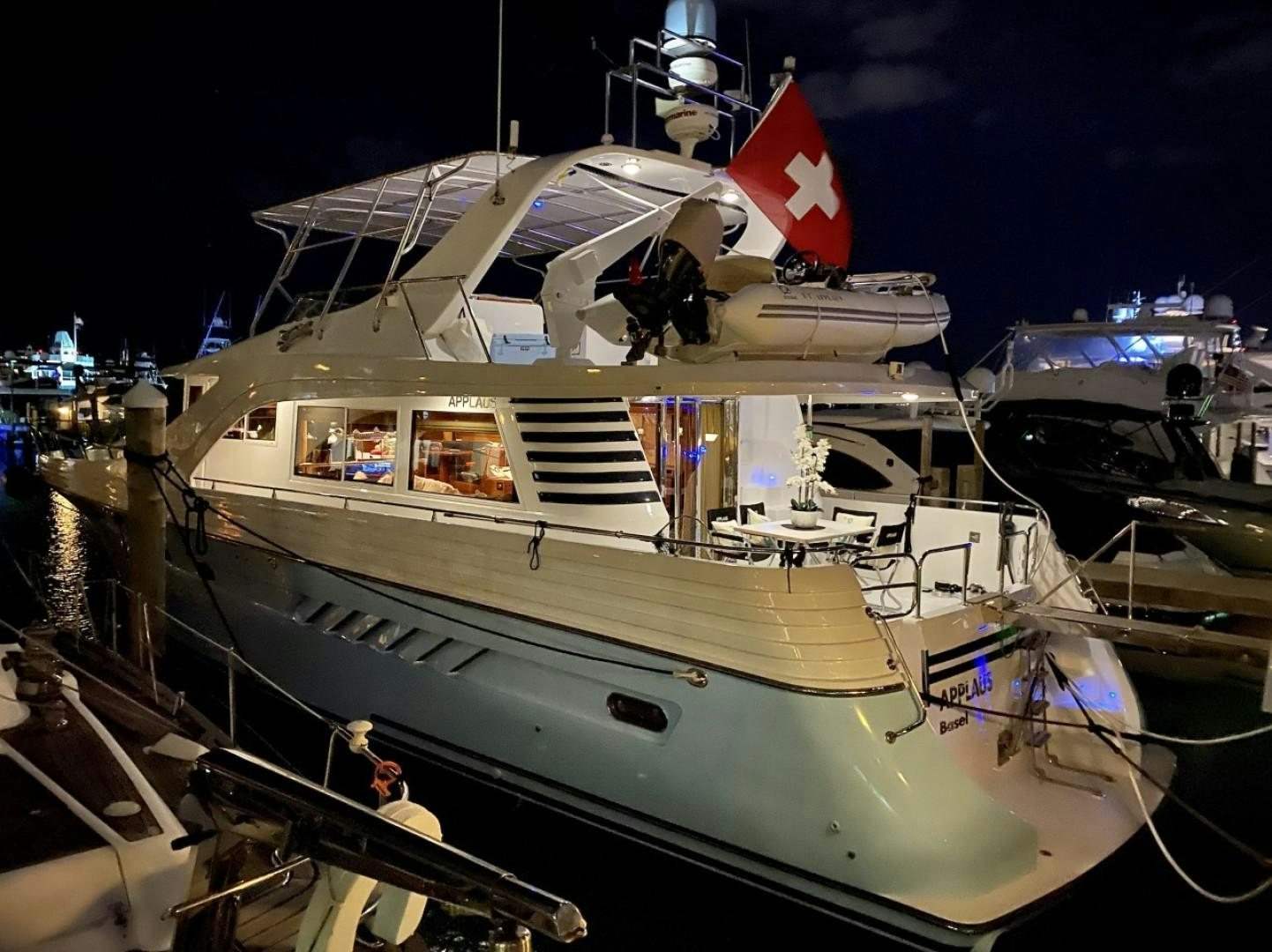 a boat with a flag on the front aboard Applaus Yacht for Sale