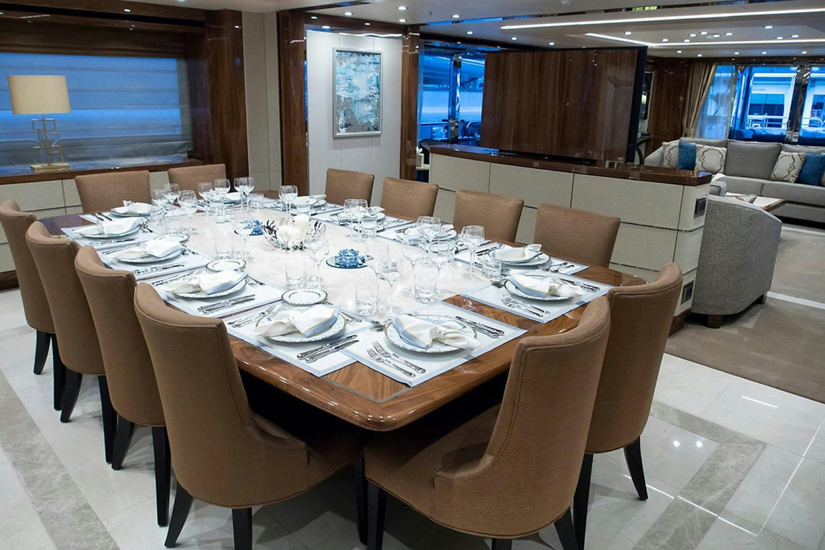 a large dining room with a table set for a dinner aboard ALESSANDRA III Yacht for Sale