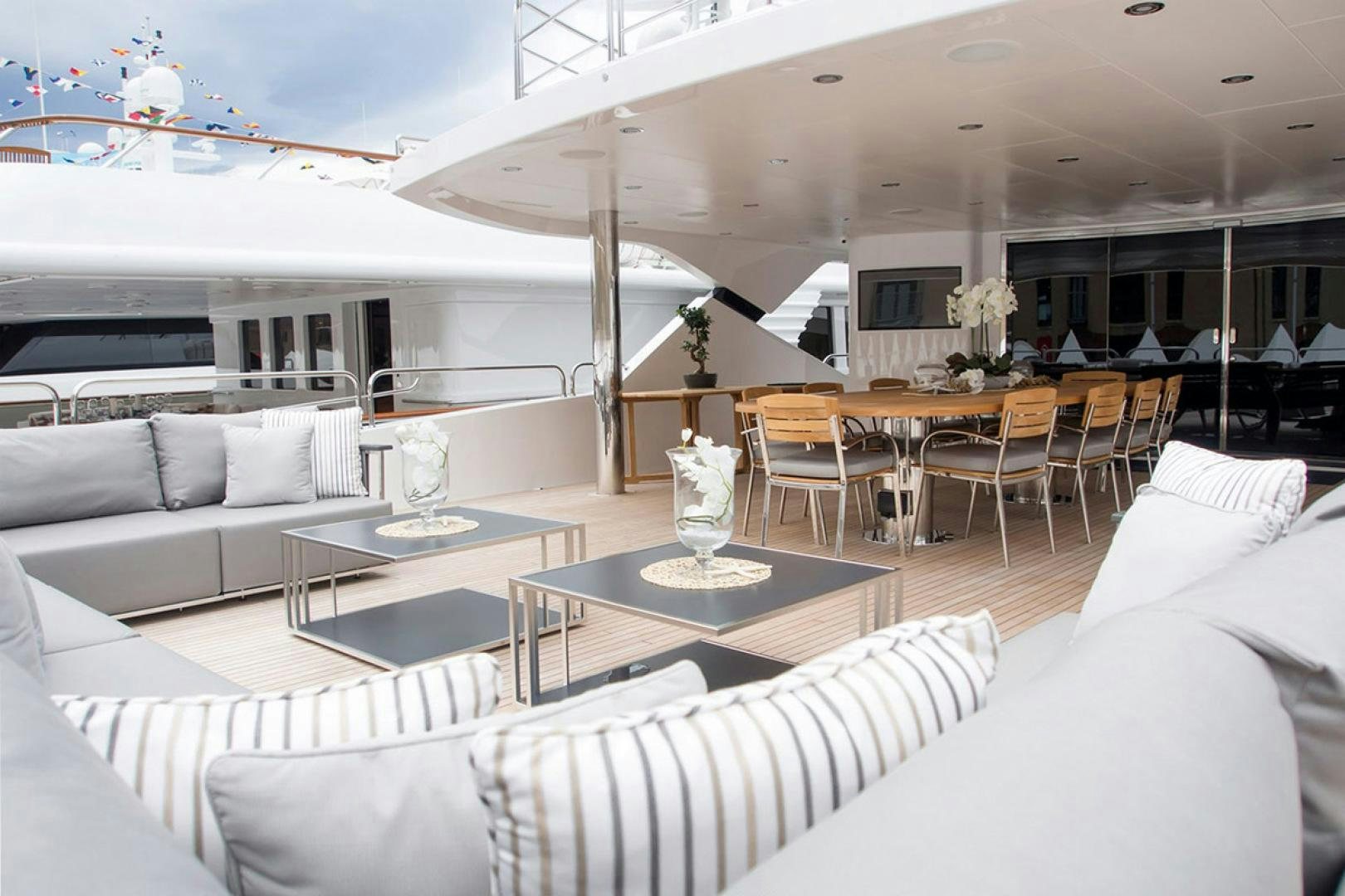 a living room with a table and couches aboard ALESSANDRA III Yacht for Sale