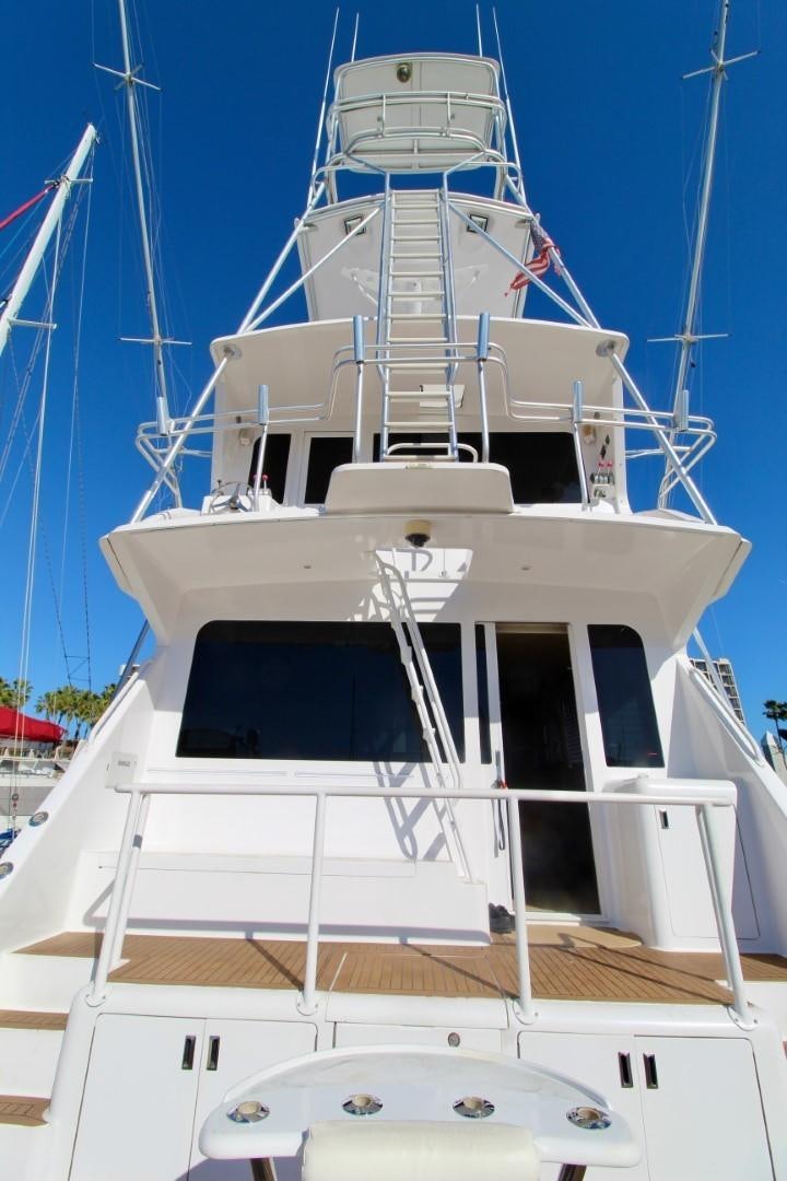 a white boat with a blue sky aboard BAD TO THE BONE Yacht for Sale