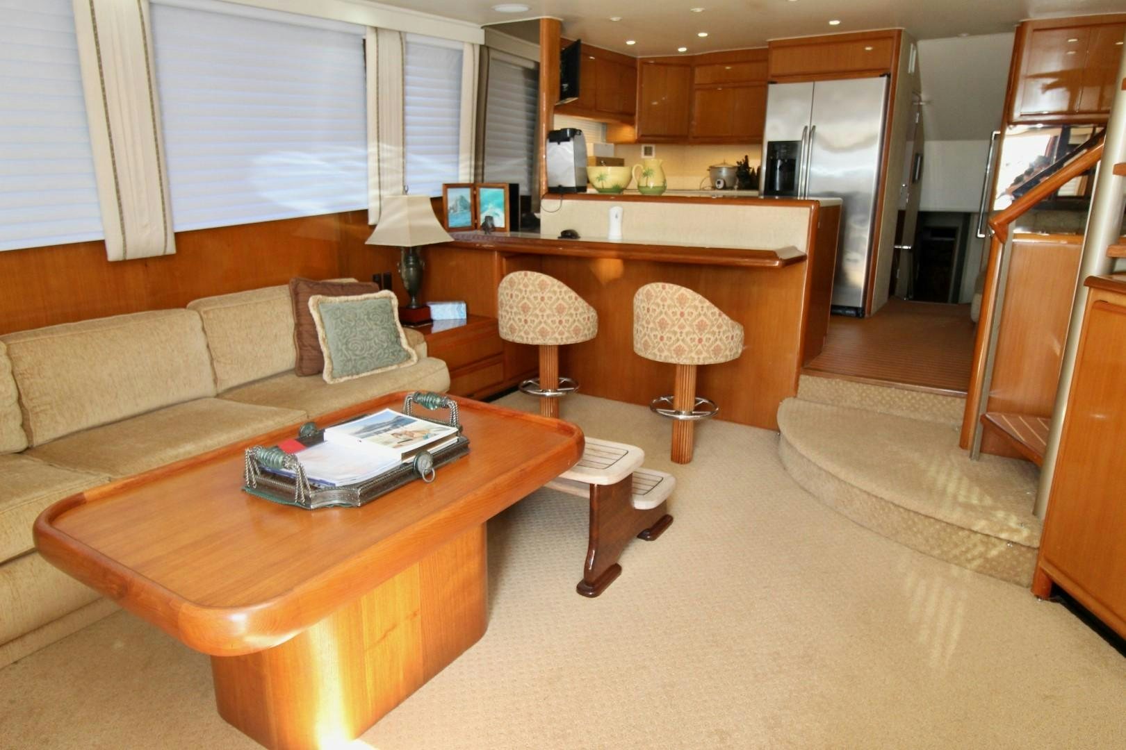 a living room with a couch and a table aboard BAD TO THE BONE Yacht for Sale