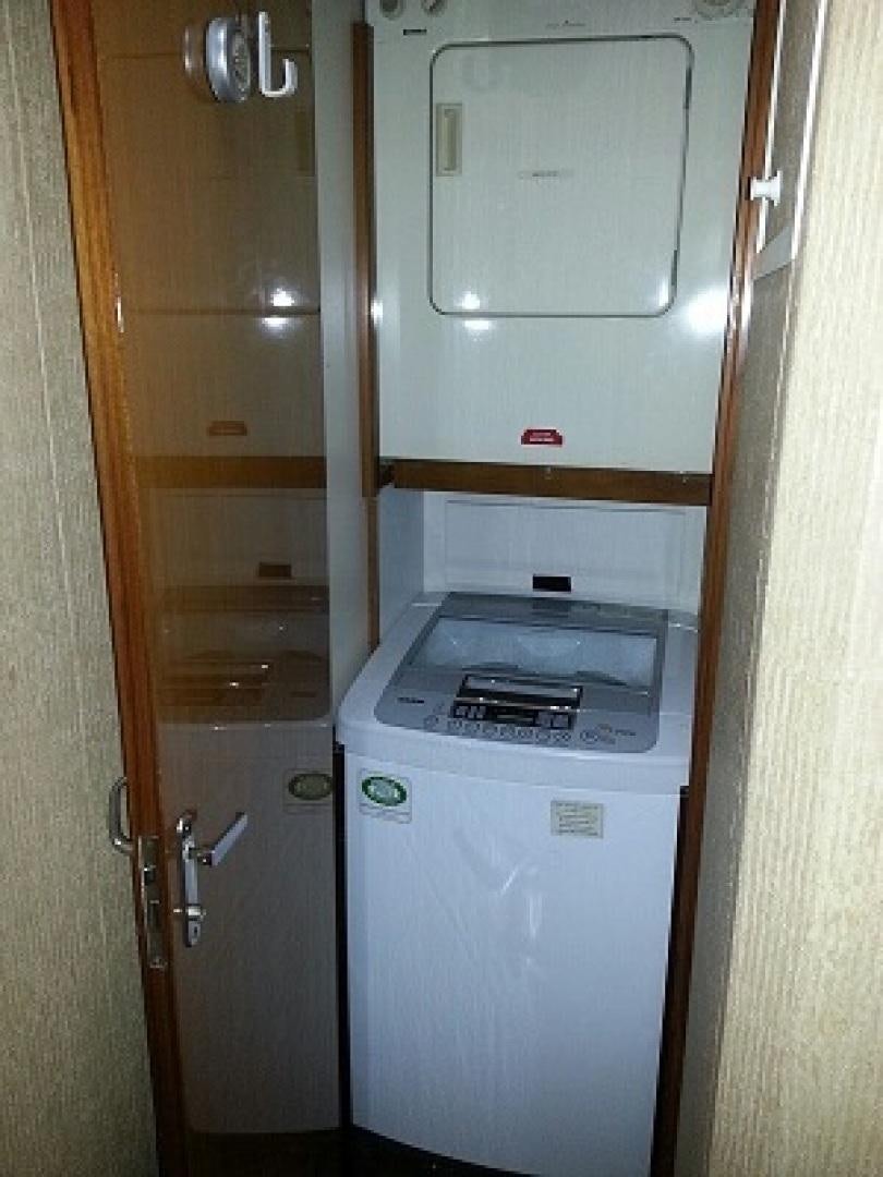 a white refrigerator in a kitchen aboard BAD TO THE BONE Yacht for Sale