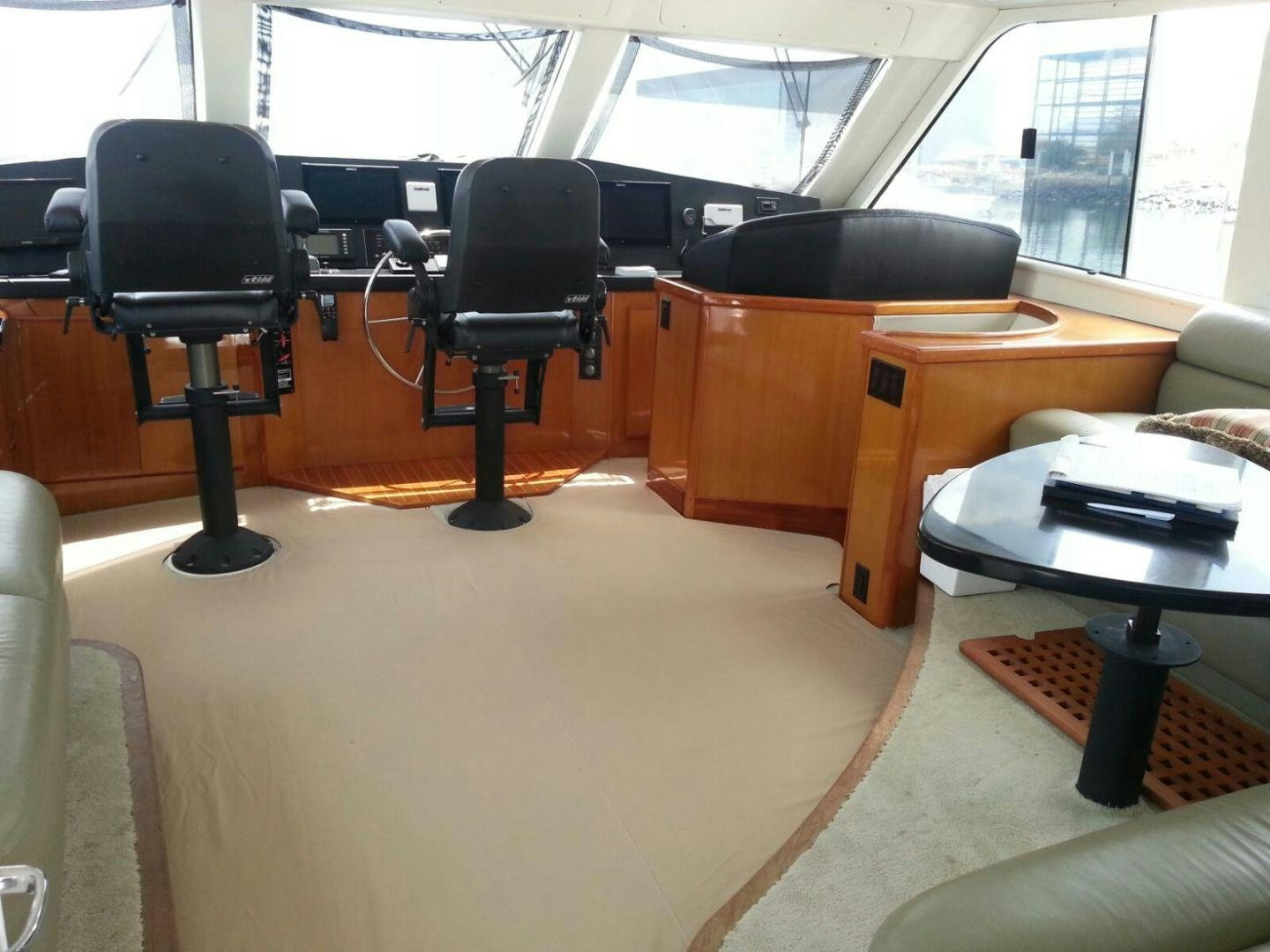 a room with a desk and chairs aboard BAD TO THE BONE Yacht for Sale