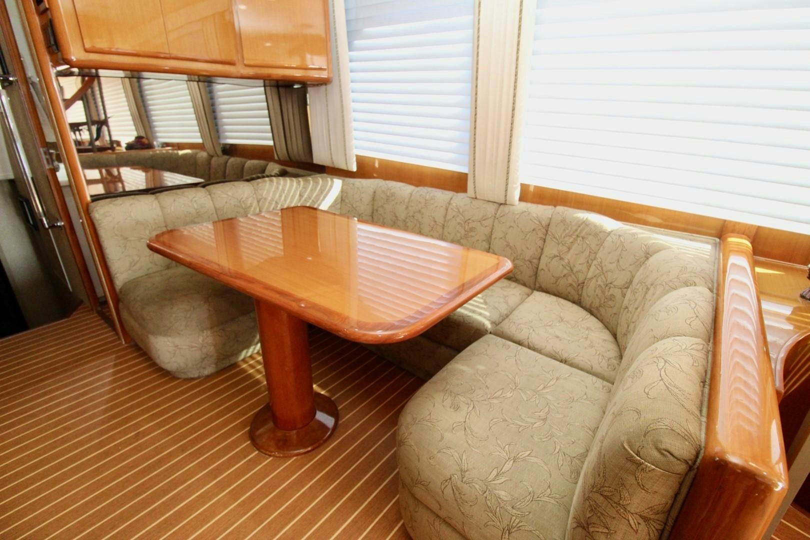 a living room with a couch and a table aboard BAD TO THE BONE Yacht for Sale