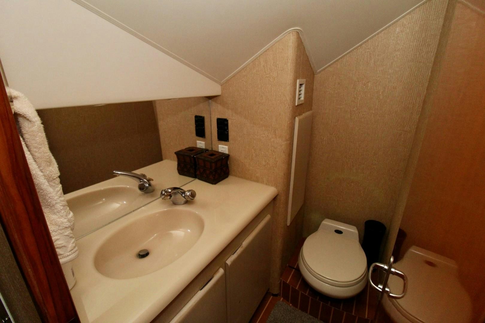 a bathroom with a toilet and sink aboard BAD TO THE BONE Yacht for Sale