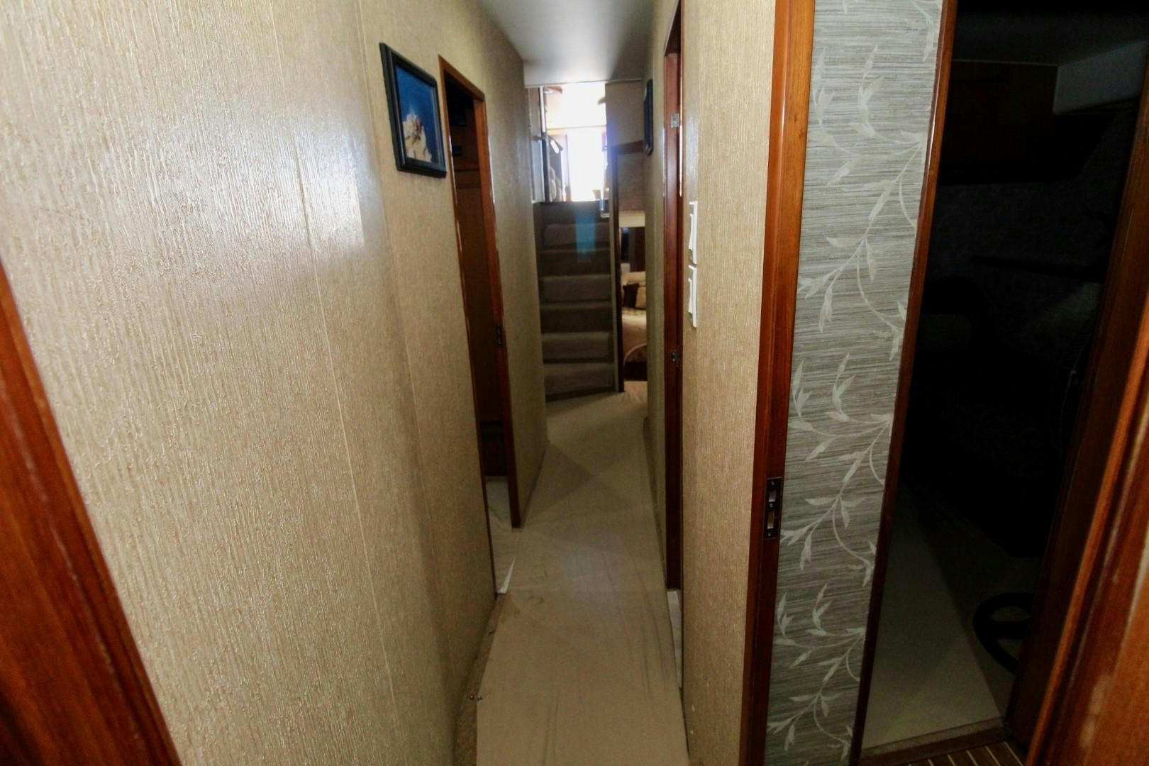 a hallway with a door and a staircase aboard BAD TO THE BONE Yacht for Sale