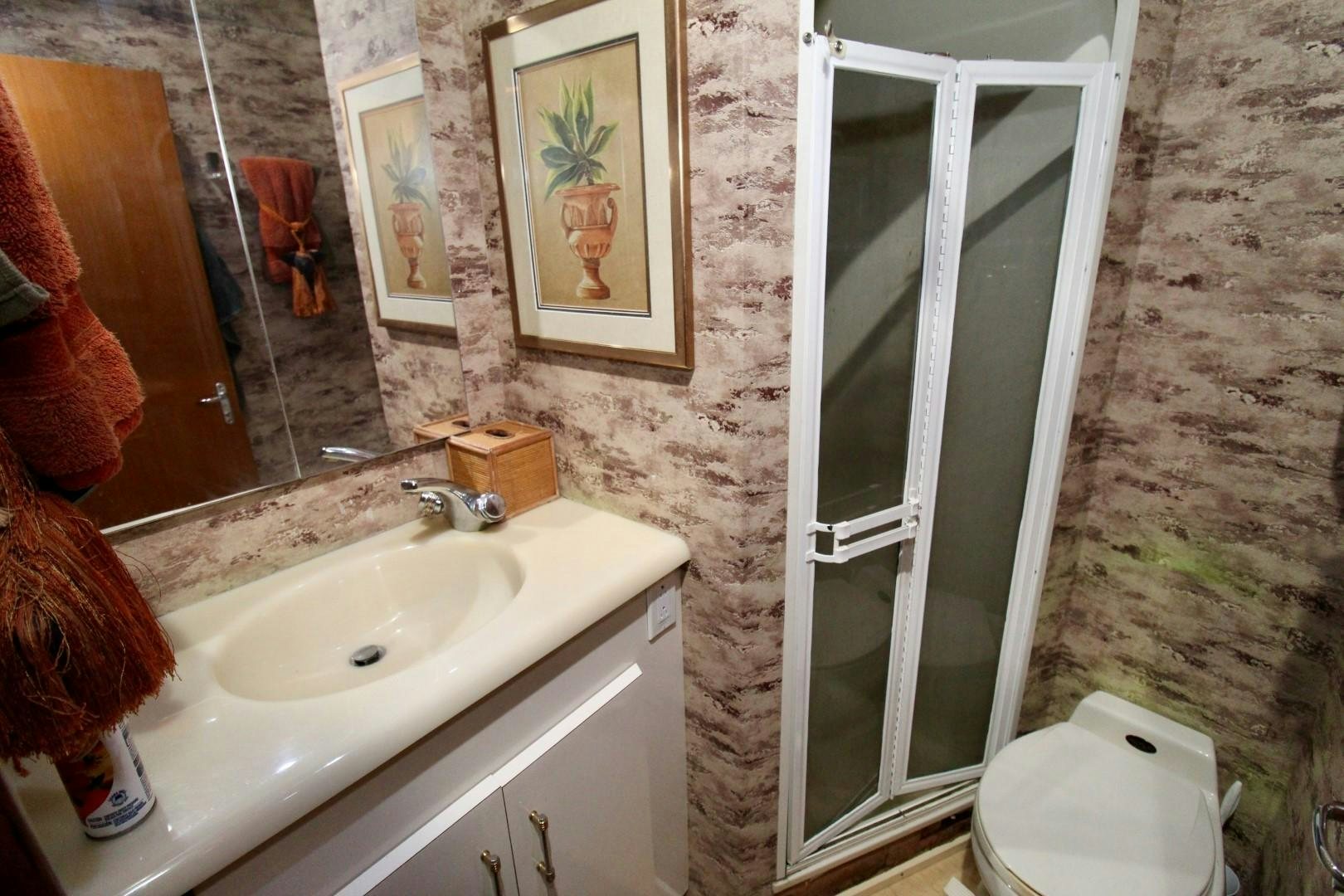 a bathroom with a sink and a toilet aboard BAD TO THE BONE Yacht for Sale