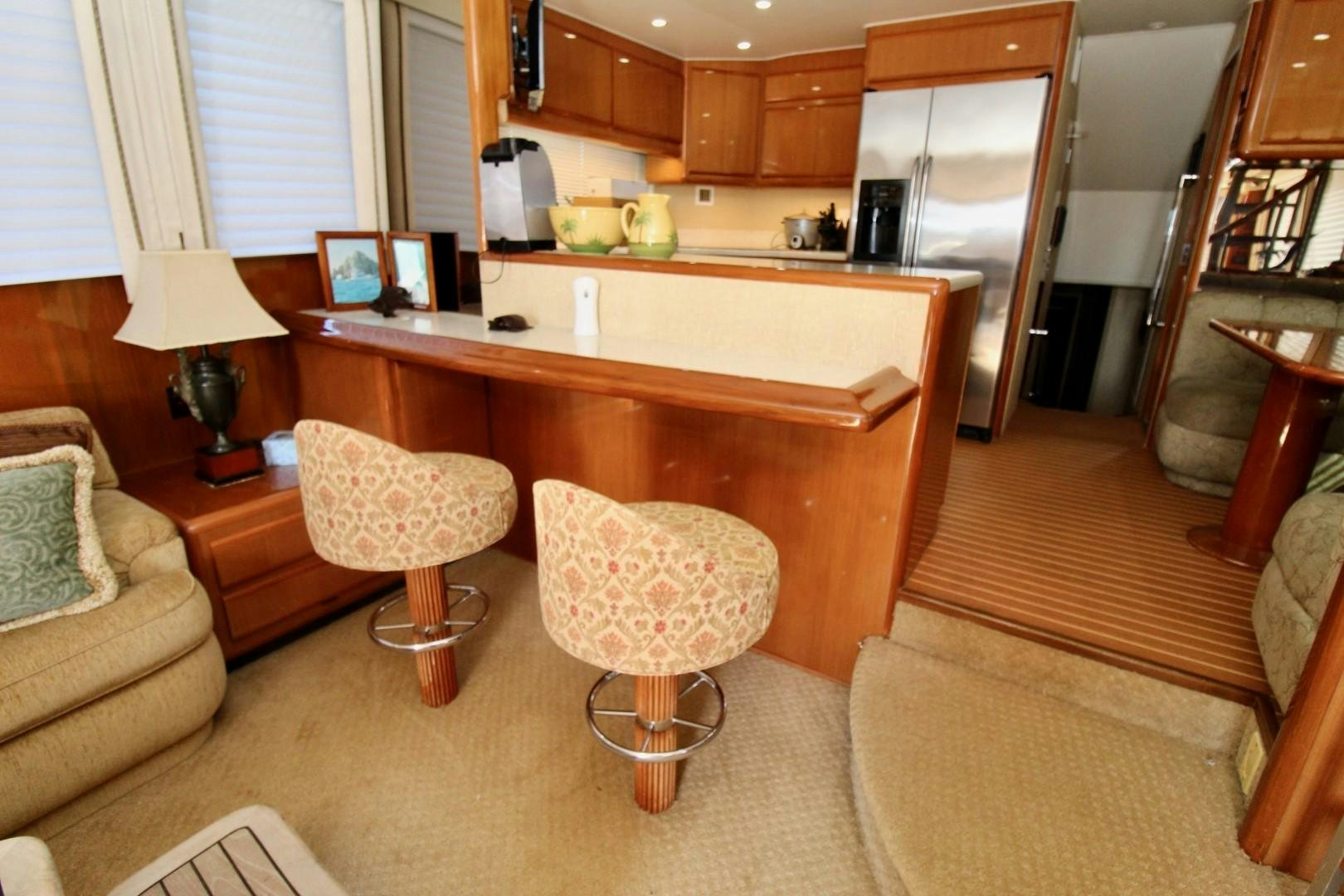 a kitchen with a table and chairs aboard BAD TO THE BONE Yacht for Sale