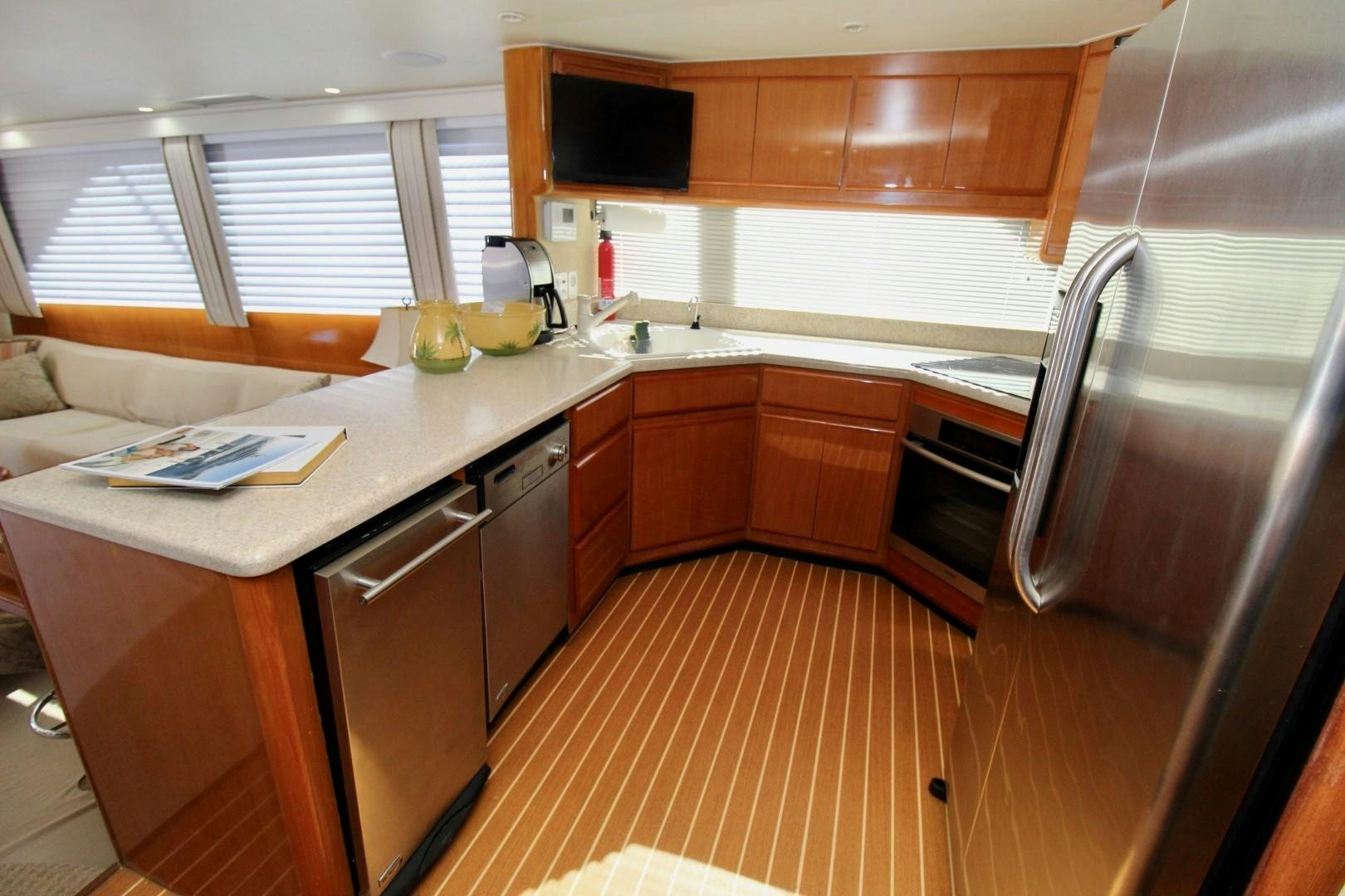 a kitchen with wooden cabinets aboard BAD TO THE BONE Yacht for Sale