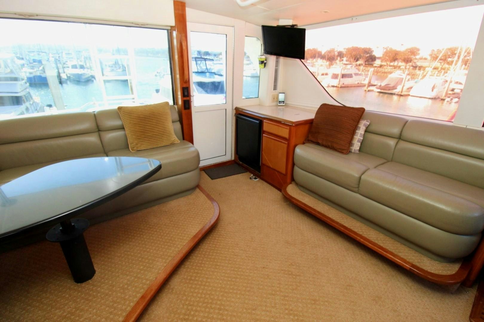 a living room with a couch and a tv aboard BAD TO THE BONE Yacht for Sale