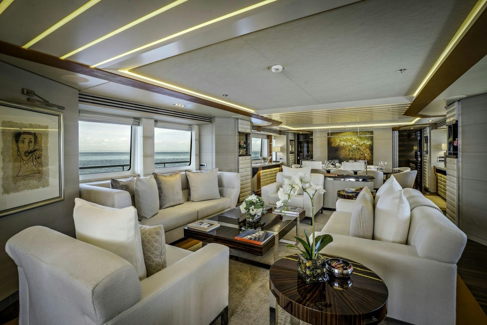 a living room with white couches and a coffee table aboard ODYSSEA Yacht for Charter