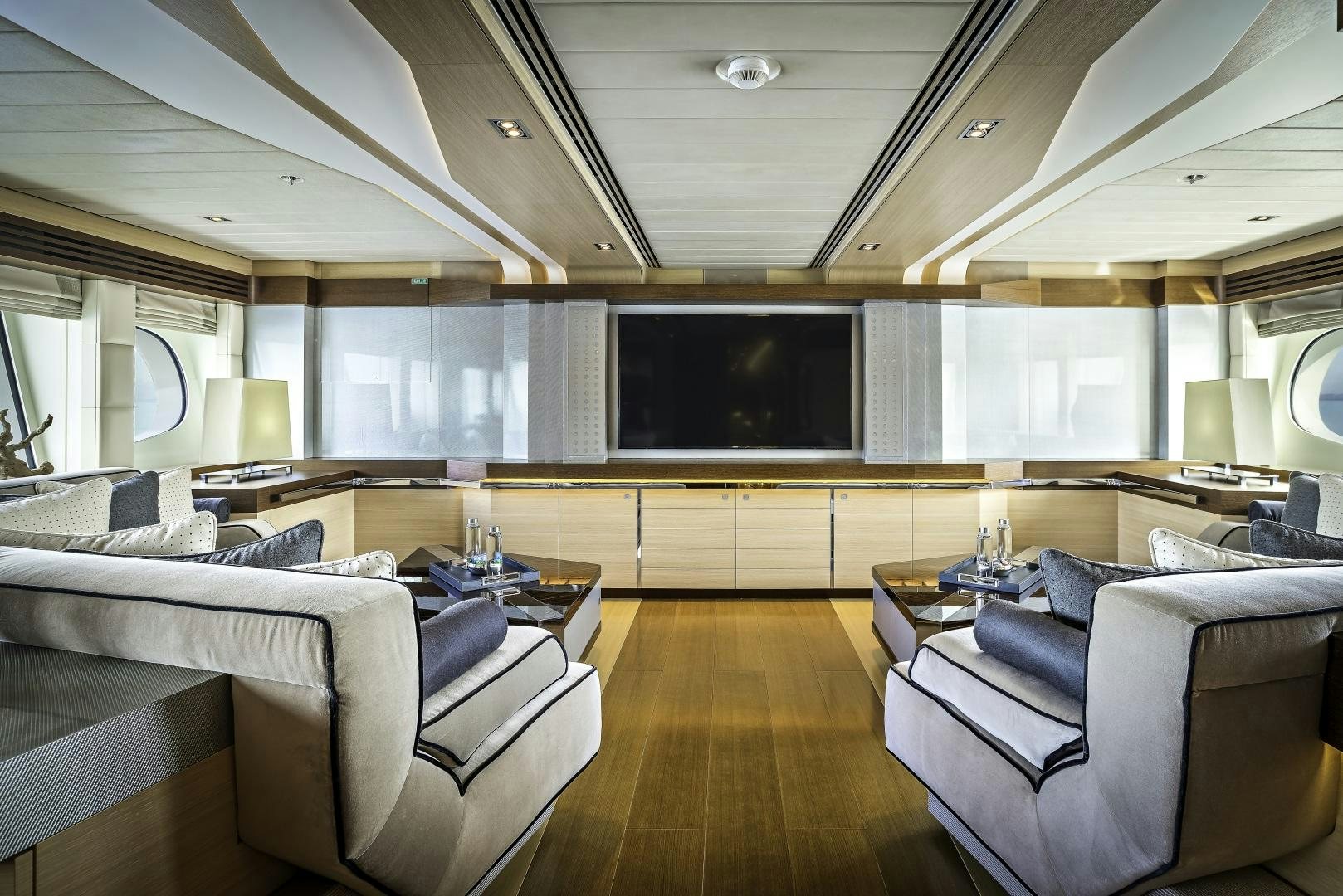 a living room with a large screen aboard ODYSSEA Yacht for Charter