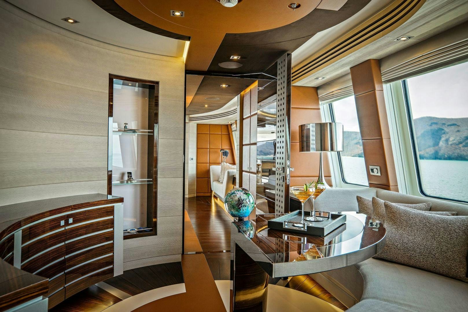 a room with a bed and a table aboard ODYSSEA Yacht for Charter