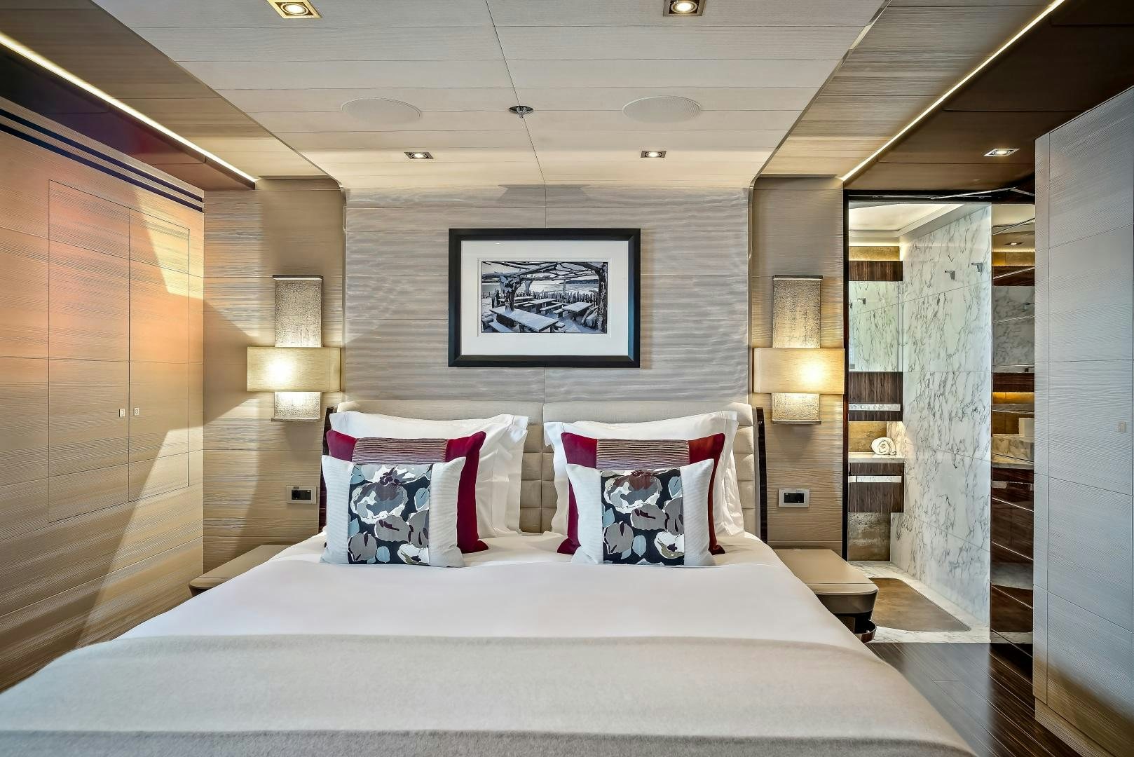 a bed with white sheets and pillows aboard ODYSSEA Yacht for Charter