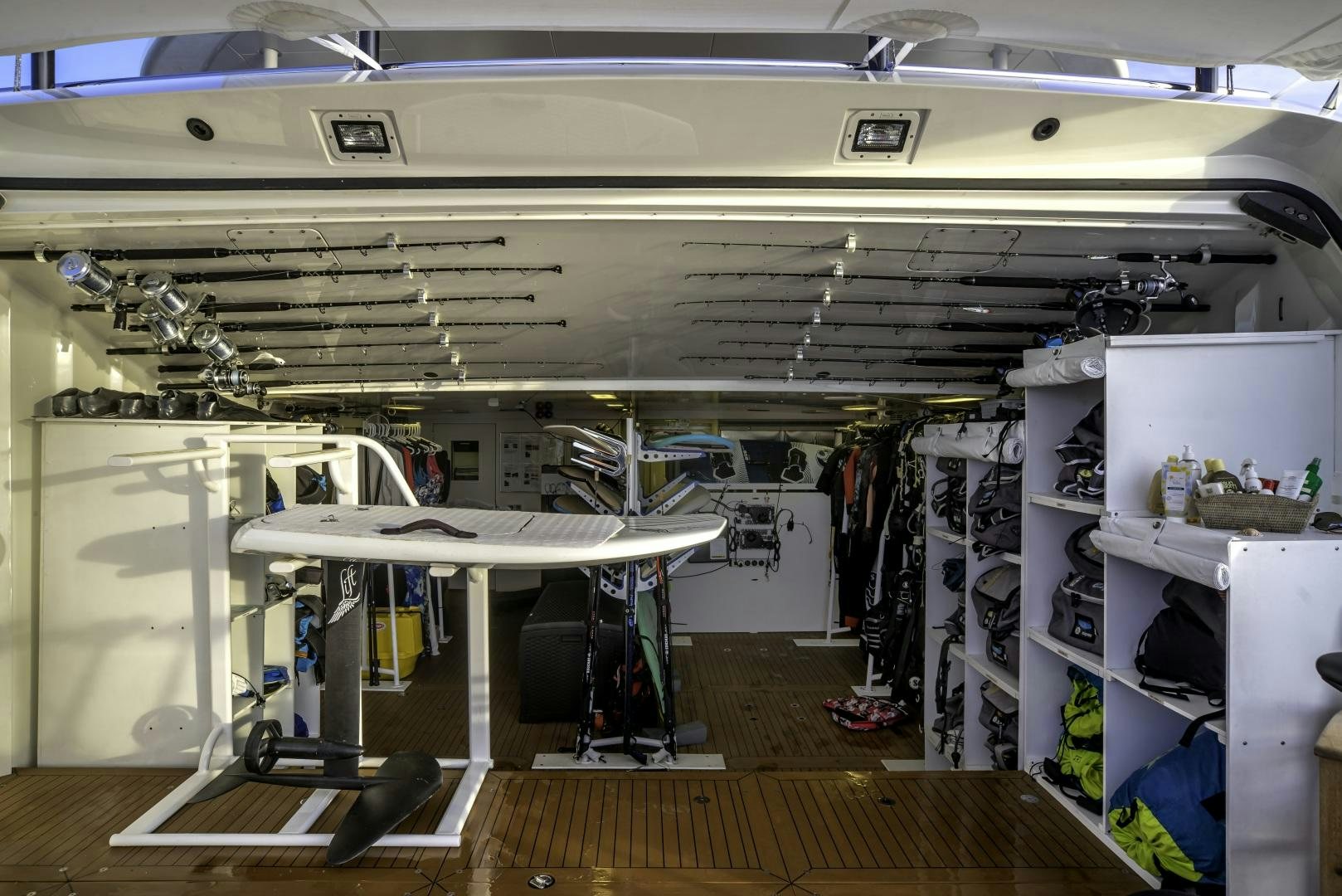 a room with a table and a shelf with objects on it aboard ODYSSEA Yacht for Charter