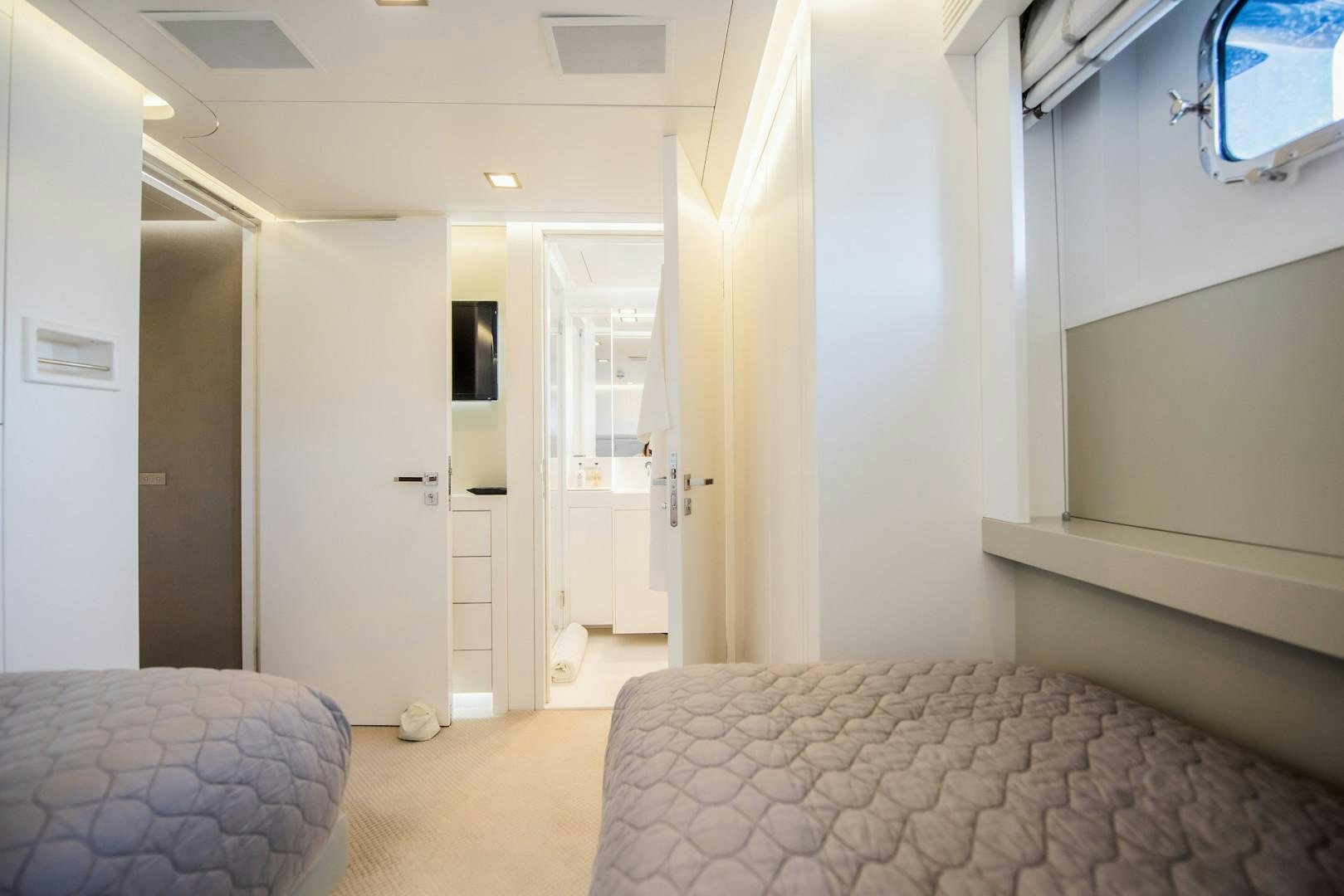 a room with a bed and a window aboard OCEAN'S SEVEN Yacht for Sale