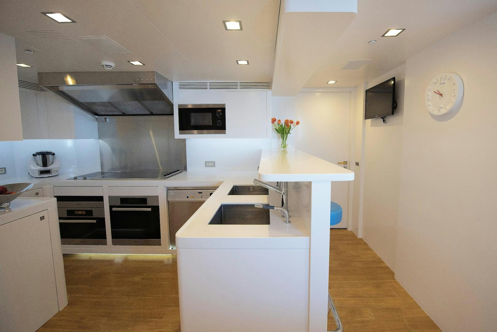 a kitchen with white cabinets aboard OCEAN'S SEVEN Yacht for Sale