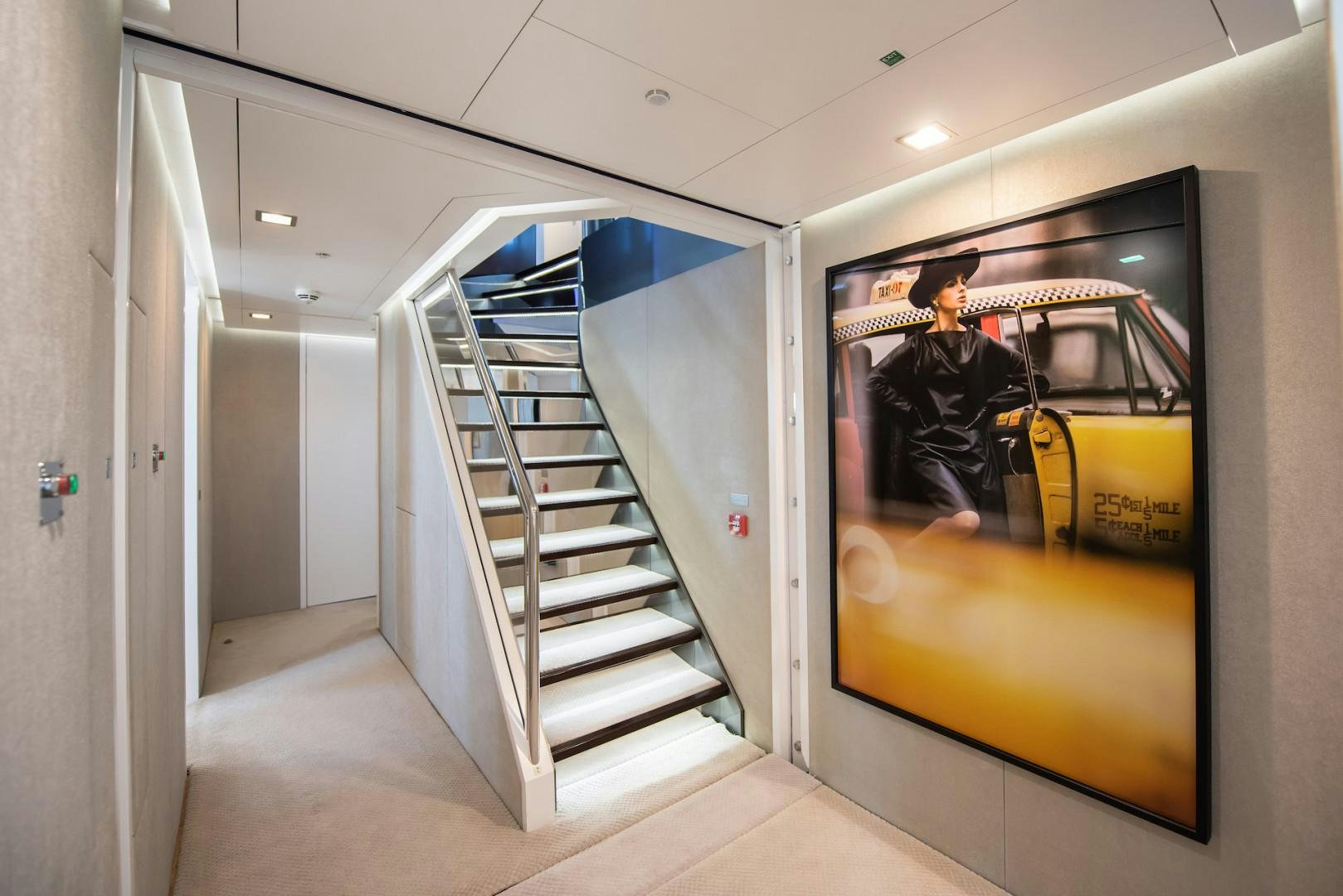 a set of stairs leading to a room with a person standing in the door aboard OCEAN'S SEVEN Yacht for Sale