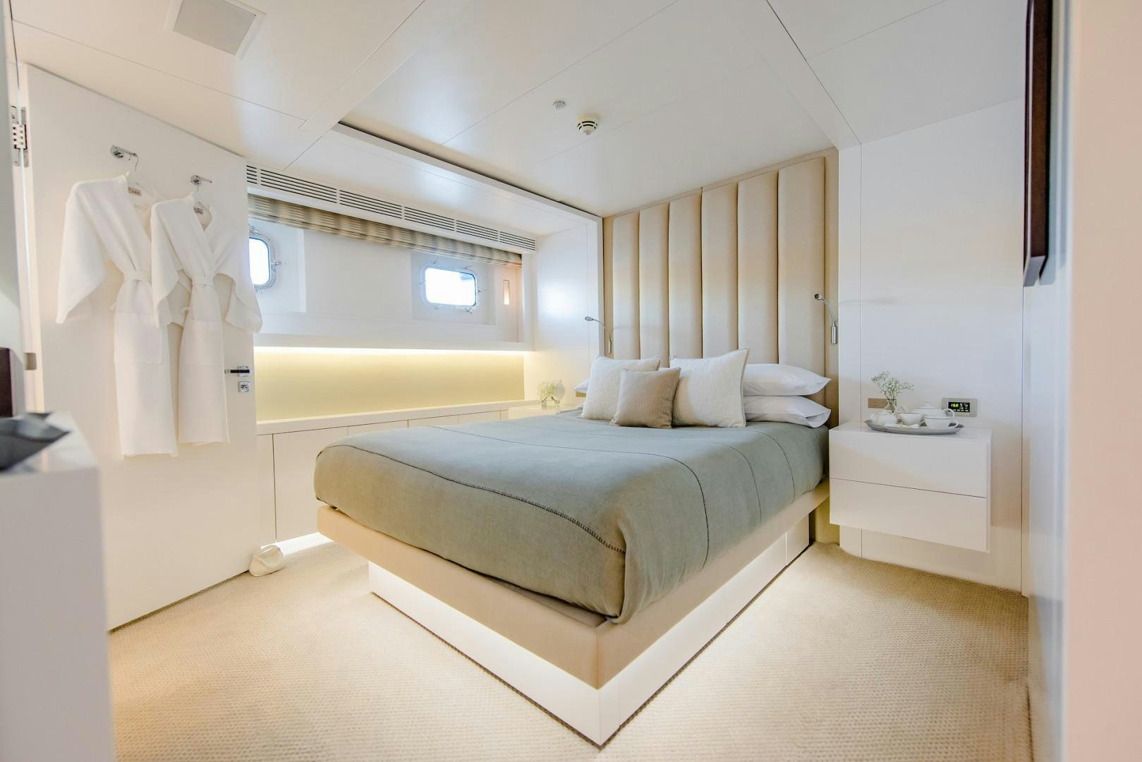 a bedroom with a bed and a mirror aboard OCEAN'S SEVEN Yacht for Sale