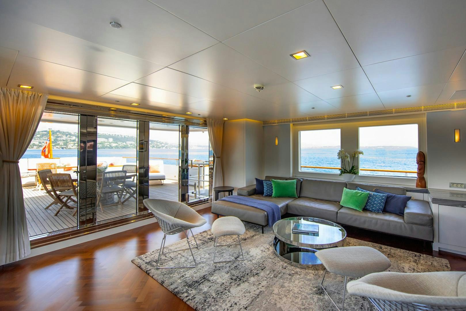 a living room with a large glass door aboard OCEAN'S SEVEN Yacht for Sale