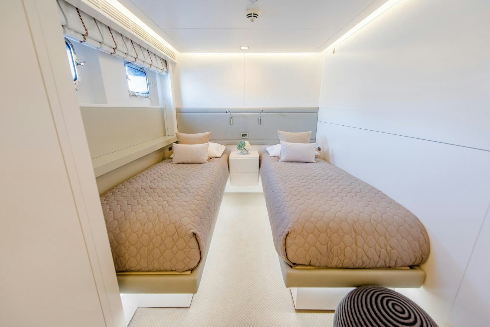a room with a bed and a chair aboard OCEAN'S SEVEN Yacht for Sale