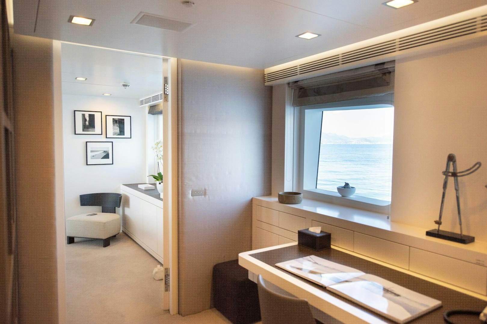a room with a desk and a bed aboard OCEAN'S SEVEN Yacht for Sale