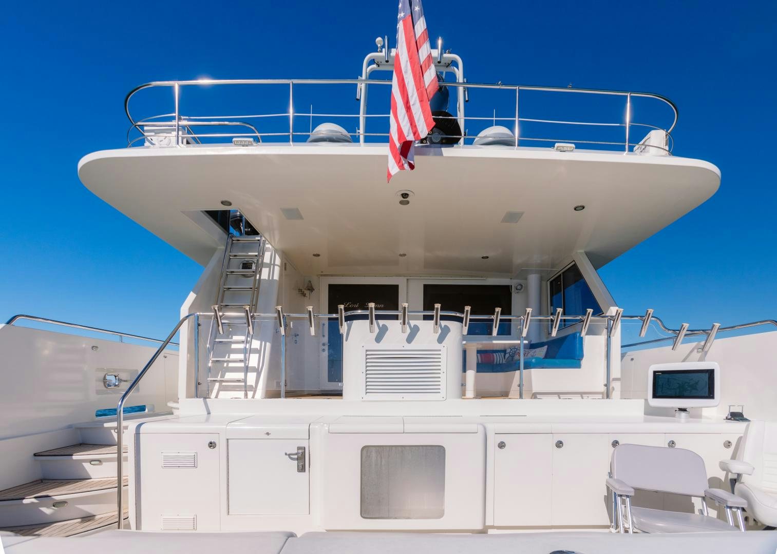a large white ship with a flag on the deck aboard LORI LYNN Yacht for Sale