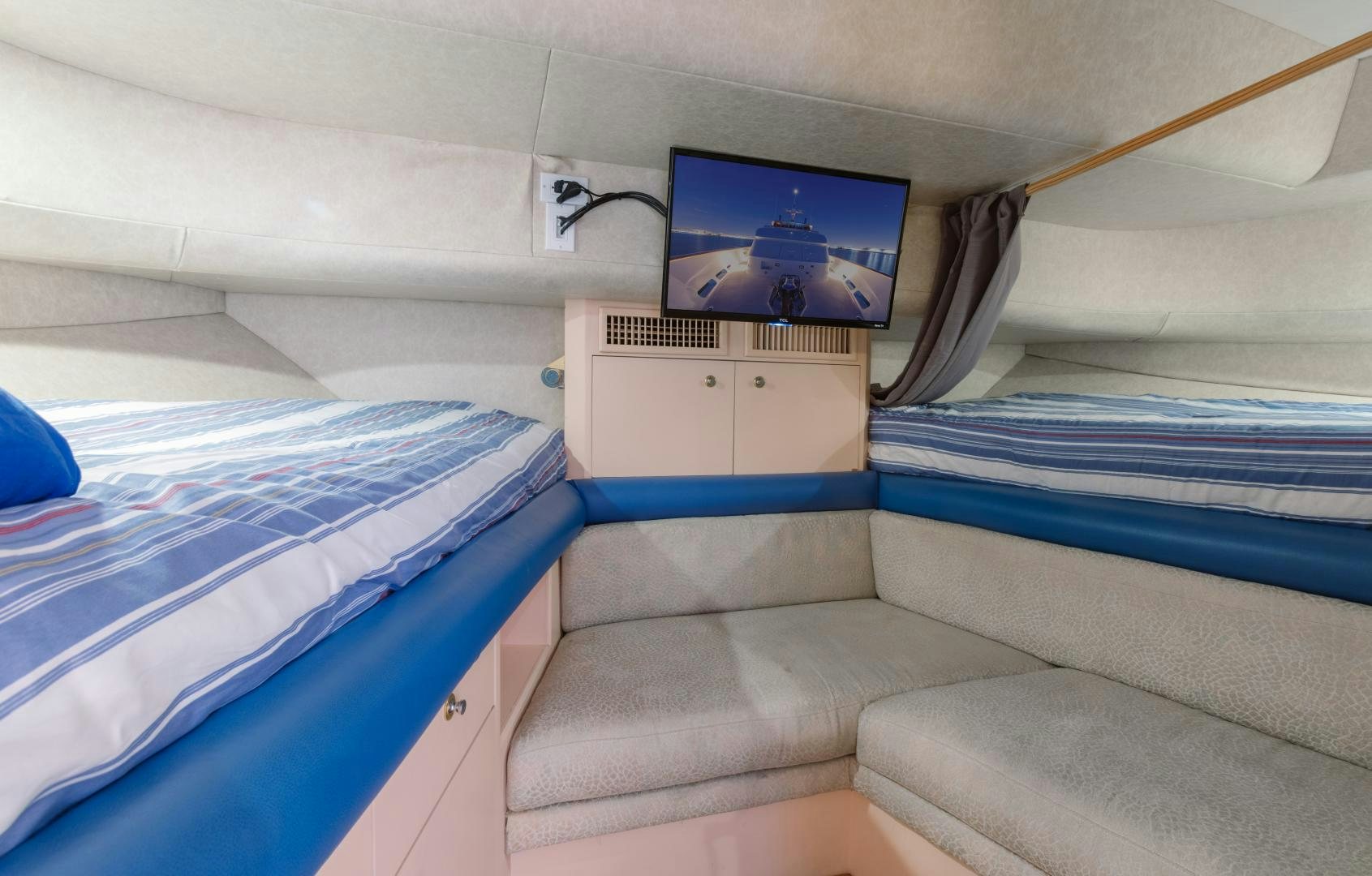 a room with a bed and a tv on the wall aboard LORI LYNN Yacht for Sale