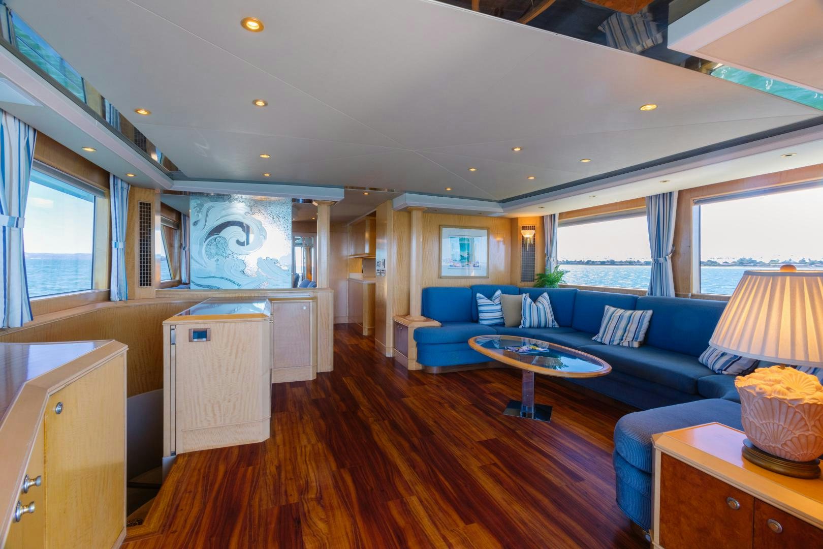 a living room with a blue couch aboard LORI LYNN Yacht for Sale