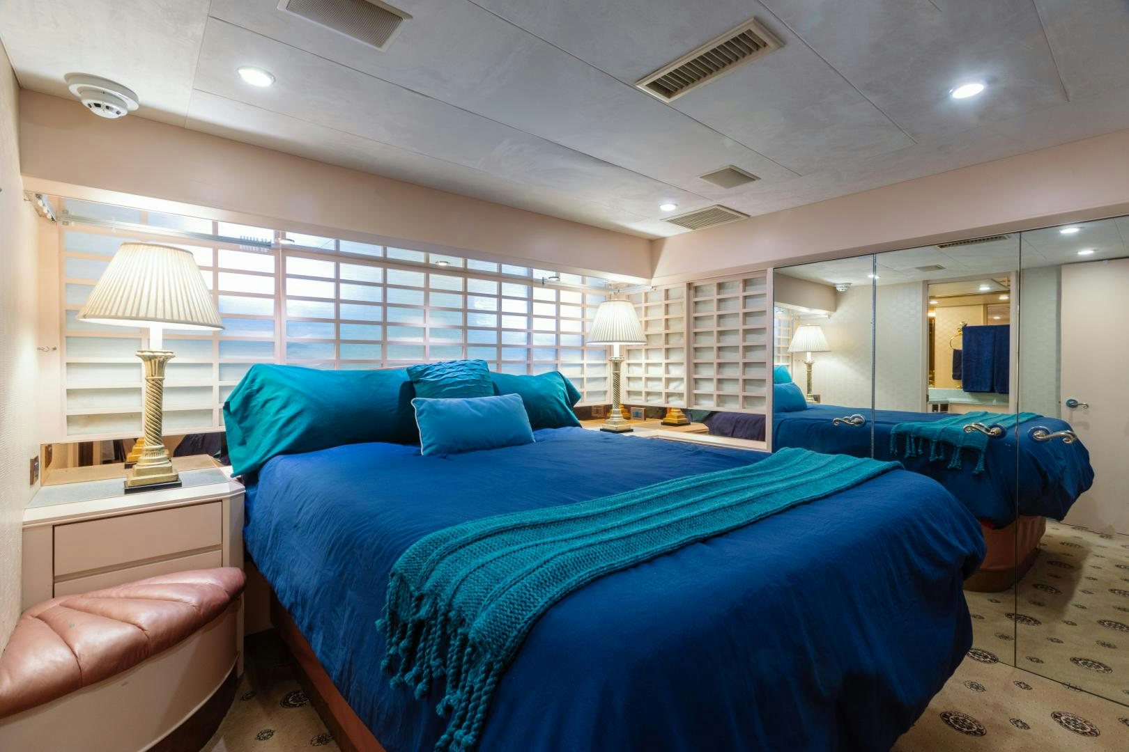 a bedroom with a blue bed aboard LORI LYNN Yacht for Sale