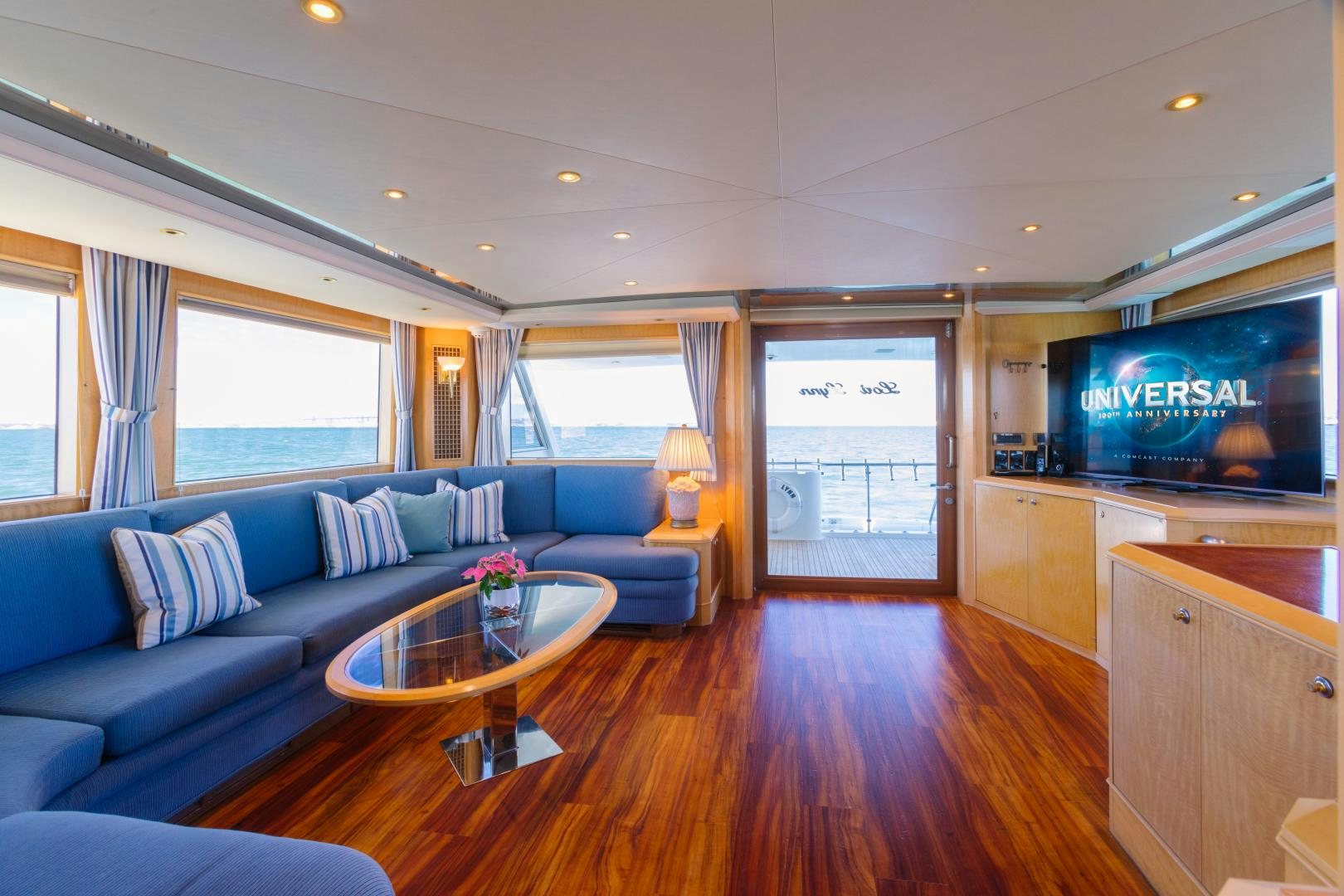 a living room with a blue couch aboard LORI LYNN Yacht for Sale