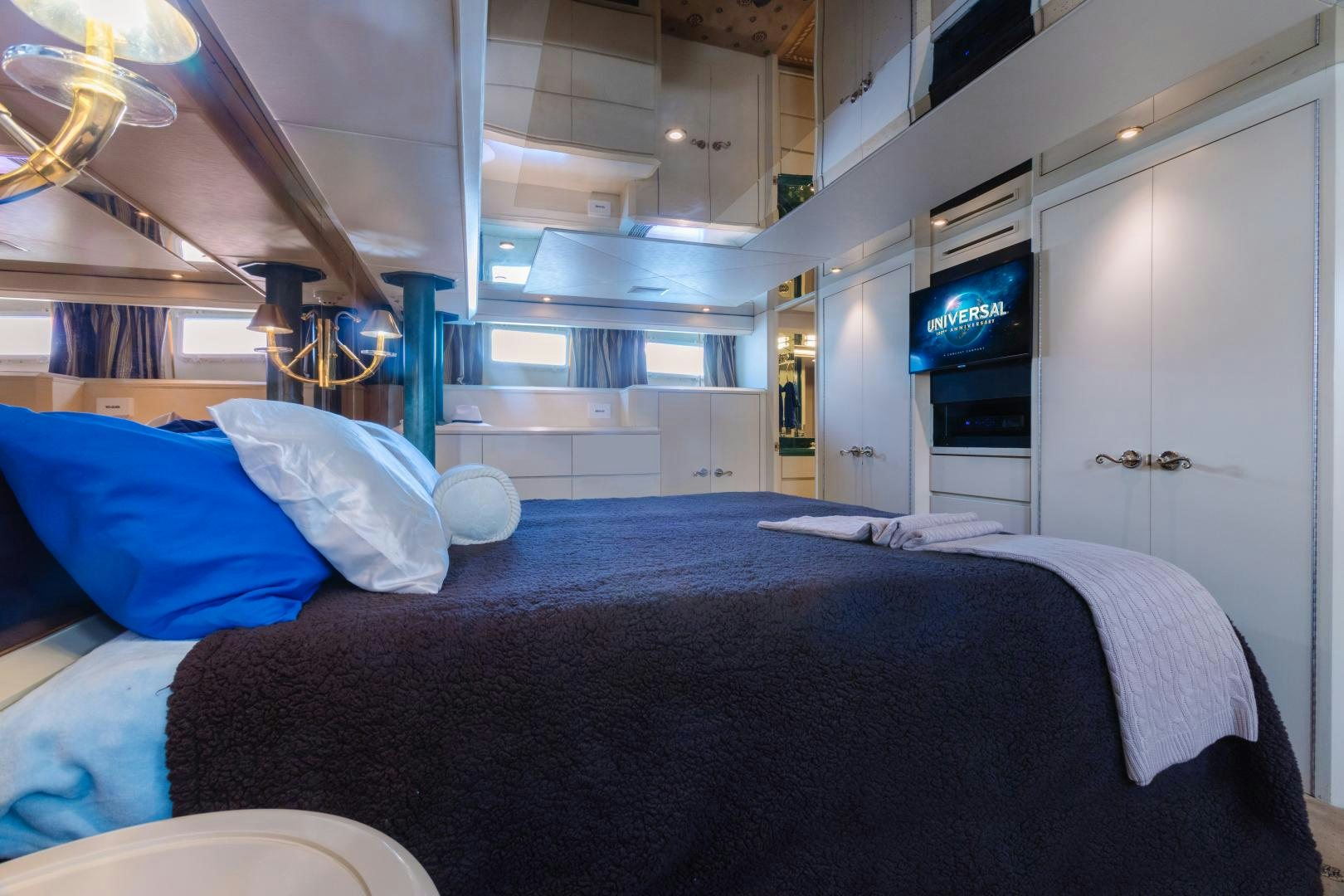 a bed with blue sheets aboard LORI LYNN Yacht for Sale
