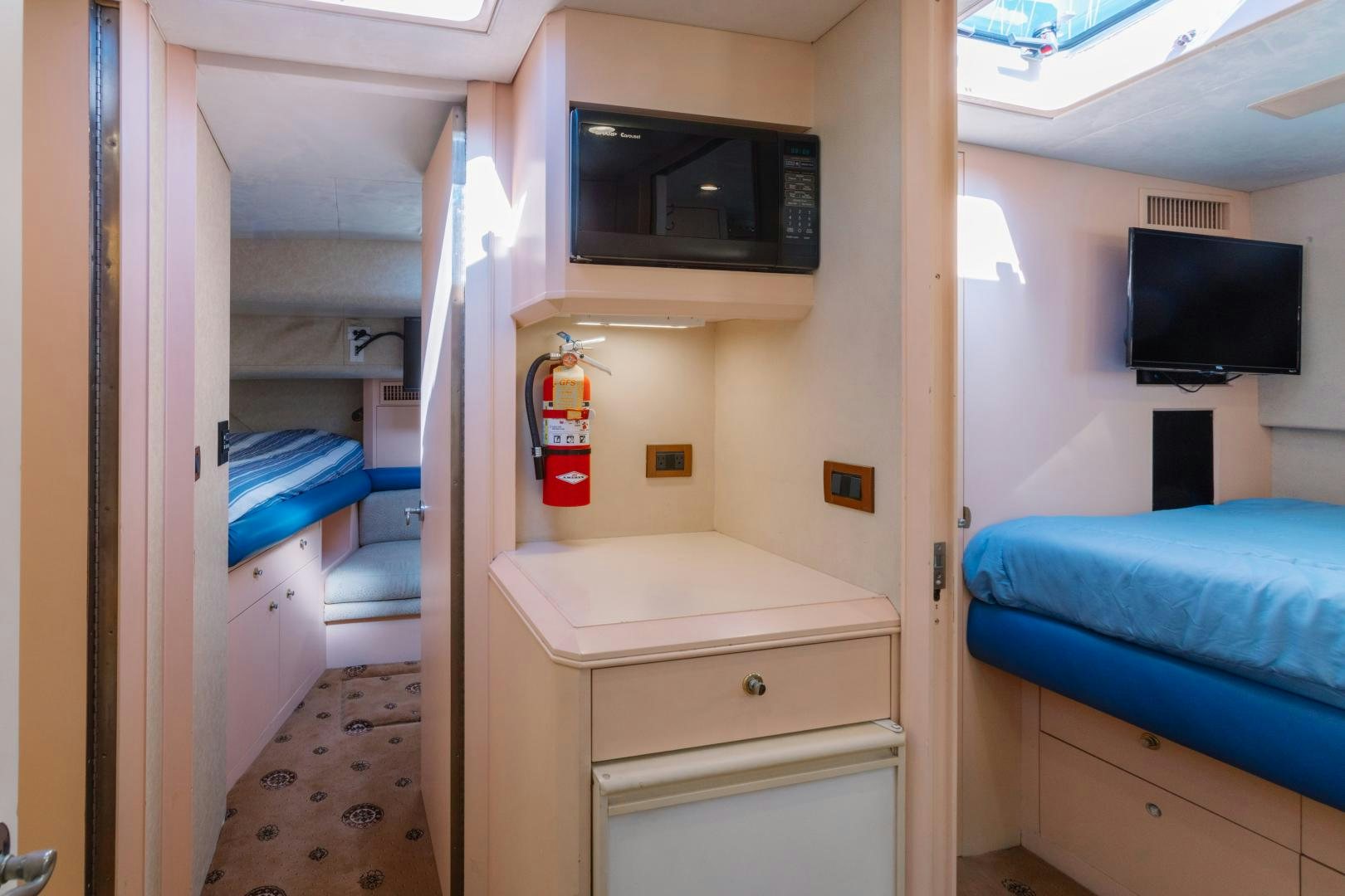 a small room with a bed and a television aboard LORI LYNN Yacht for Sale