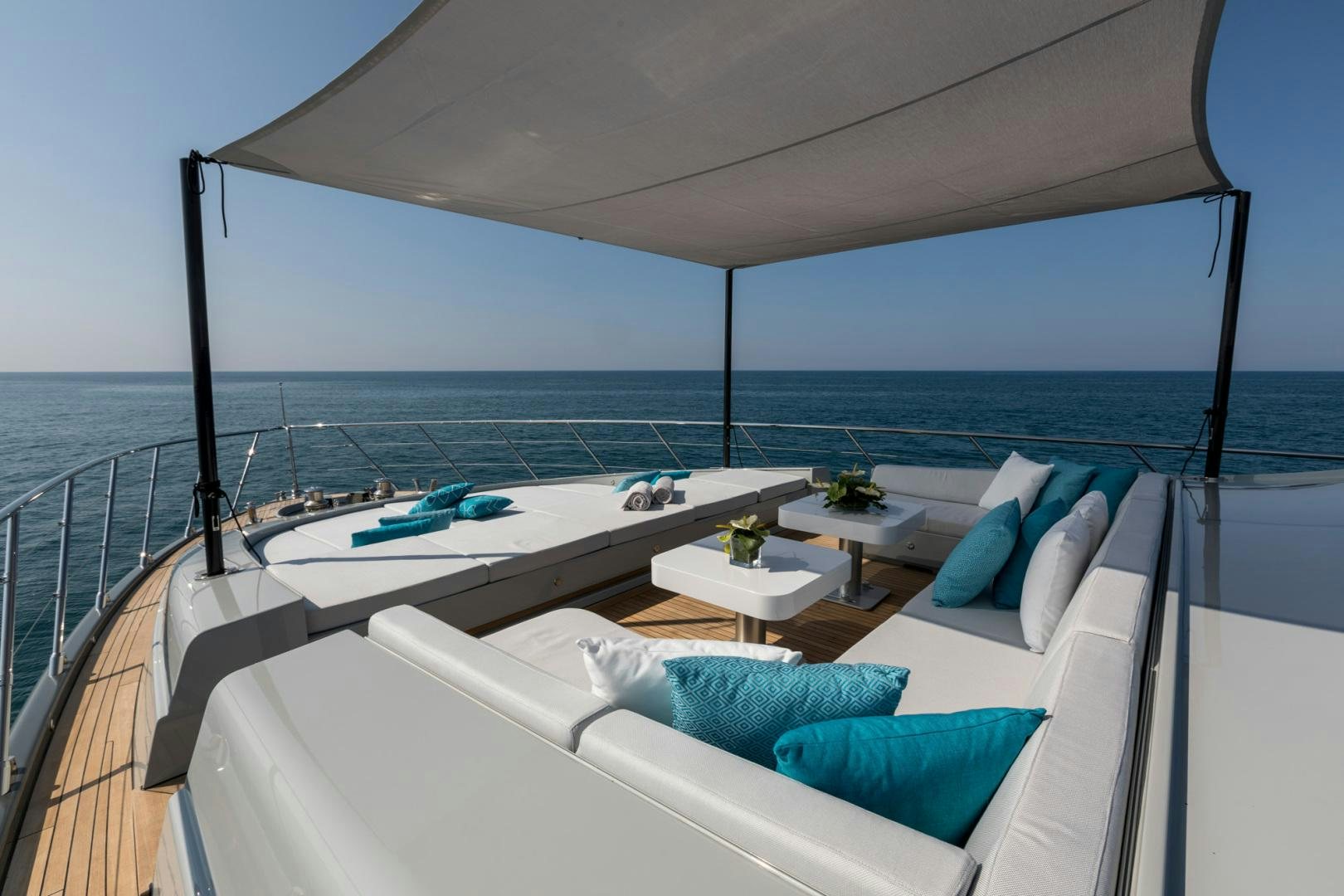 a large white bed on a balcony aboard NANA I Yacht for Sale
