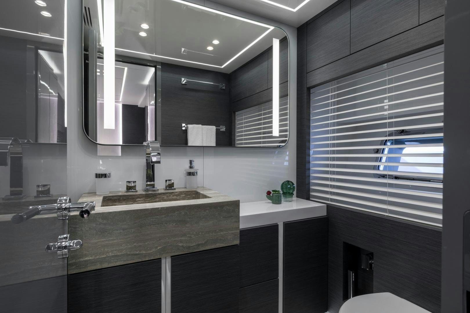 a bathroom with a countertop sink and a large mirror aboard NANA I Yacht for Sale