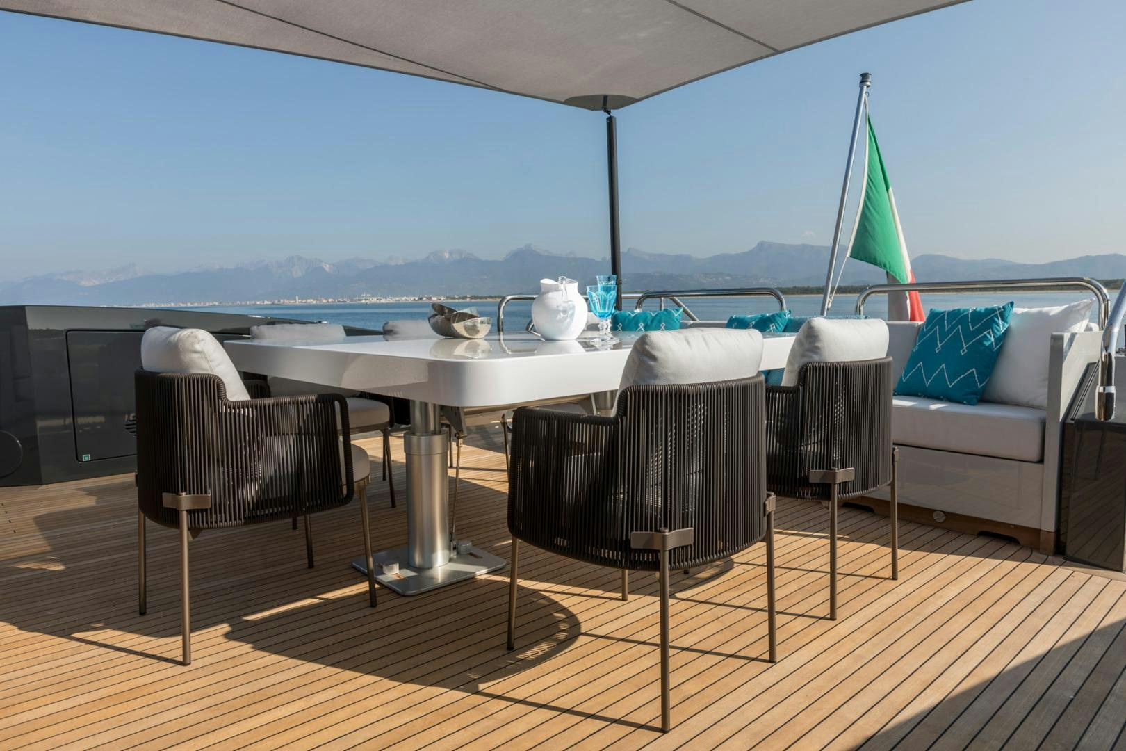 a table and chairs on a deck aboard NANA I Yacht for Sale