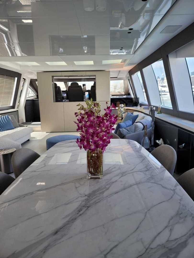 a vase of flowers on a table aboard NANA I Yacht for Sale
