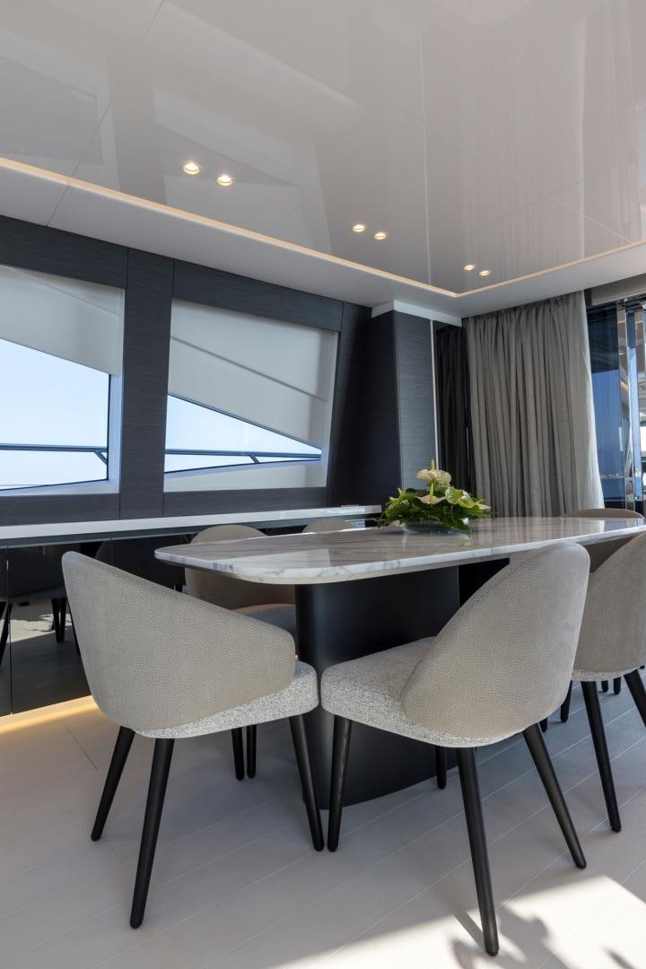 a room with a table and chairs aboard NANA I Yacht for Sale