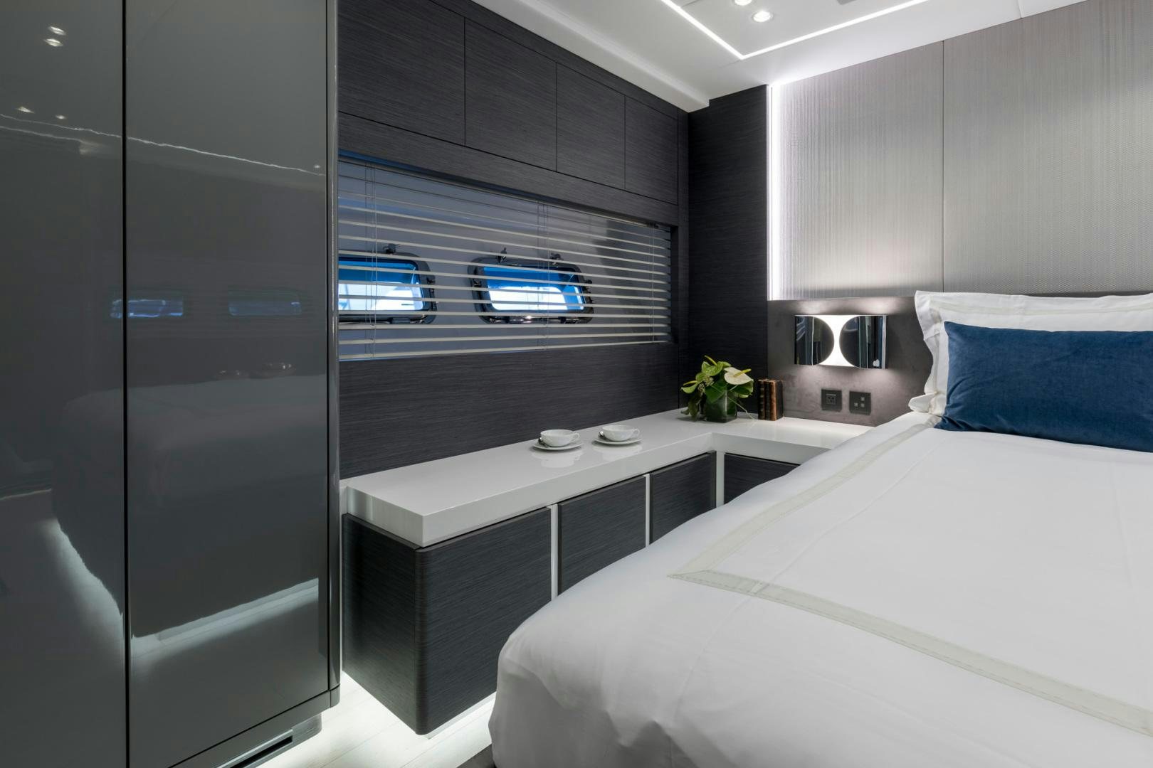 a bedroom with a bed and a desk aboard NANA I Yacht for Sale