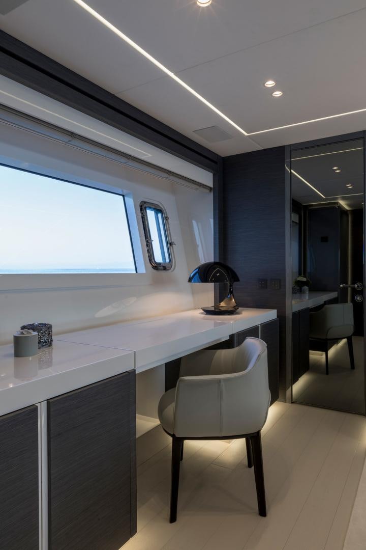 a white table with a lamp on it aboard NANA I Yacht for Sale