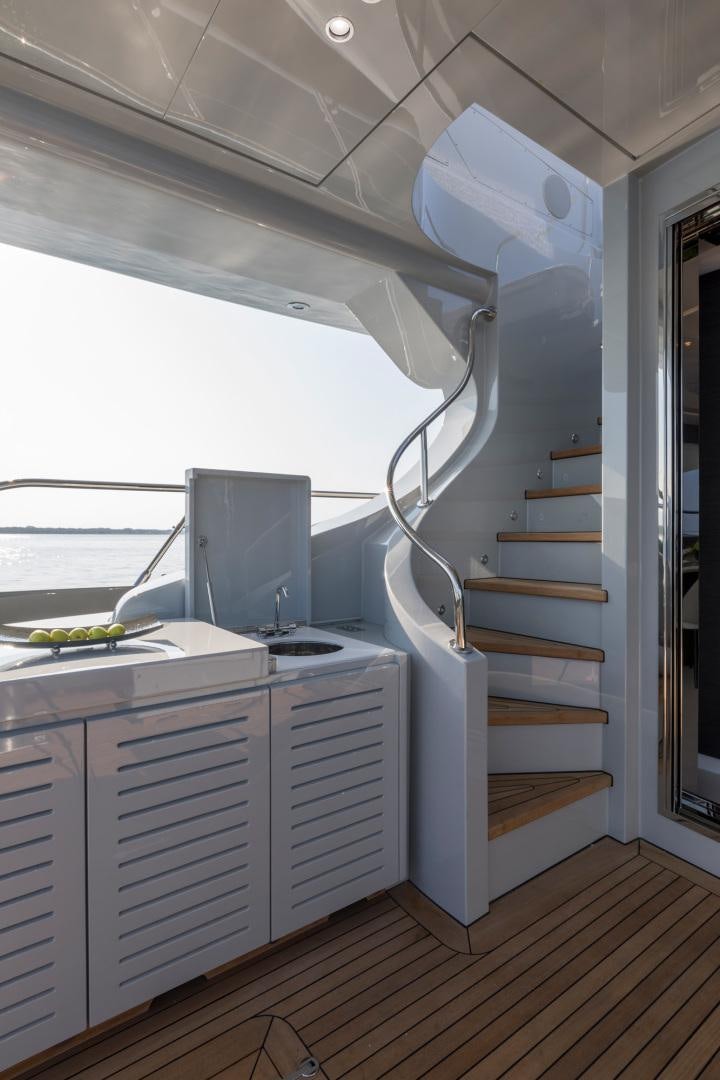 a white kitchen with a large white ladder aboard NANA I Yacht for Sale