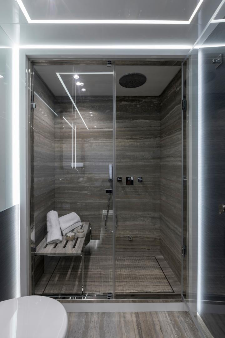 a bathroom with a glass shower aboard NANA I Yacht for Sale