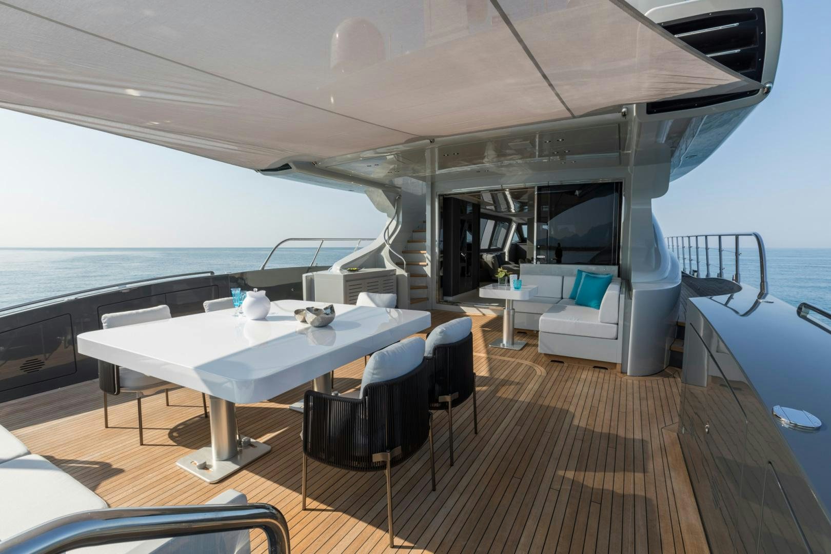 a boat with a table and chairs aboard NANA I Yacht for Sale