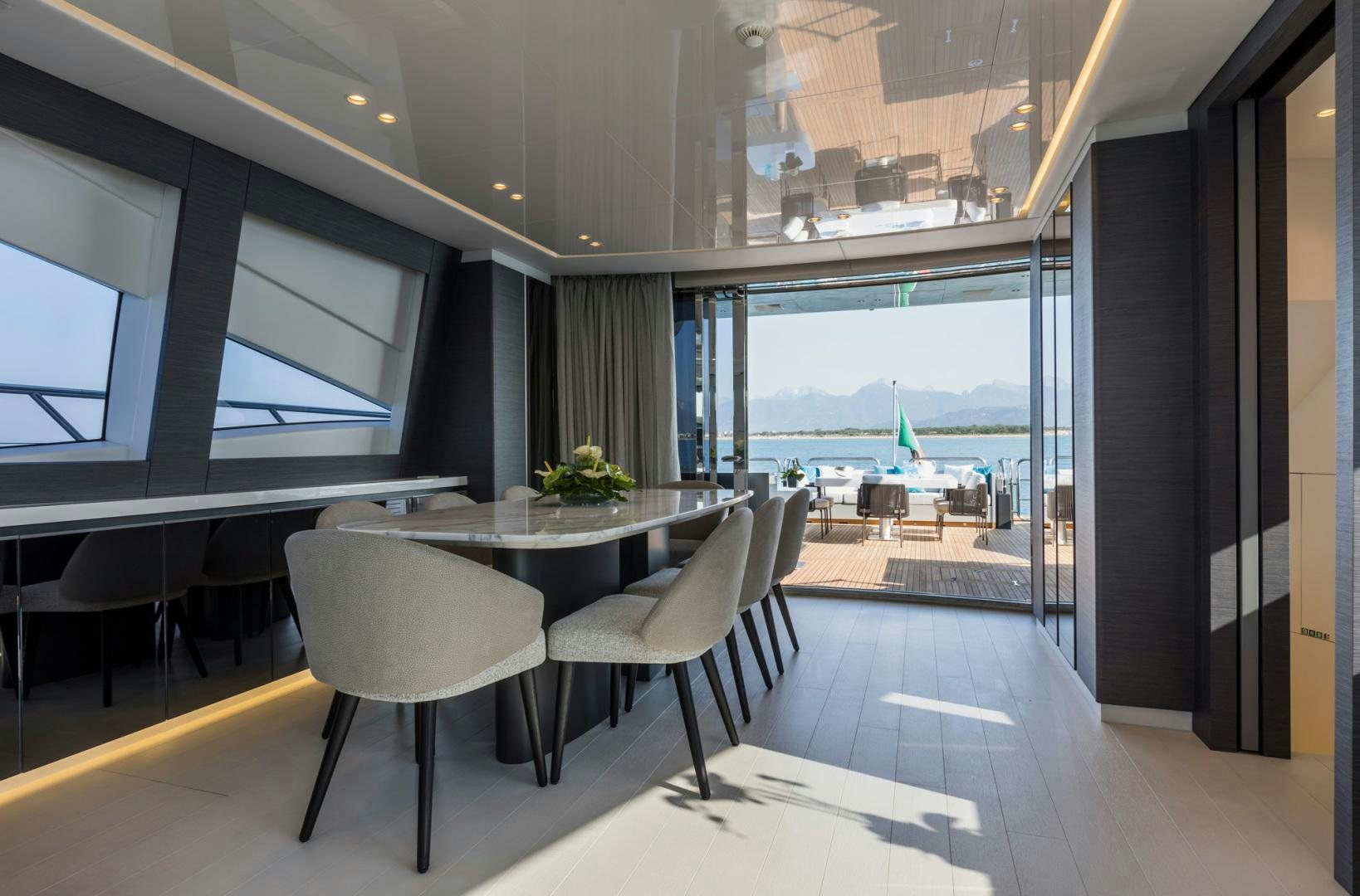 a room with tables and chairs aboard NANA I Yacht for Sale