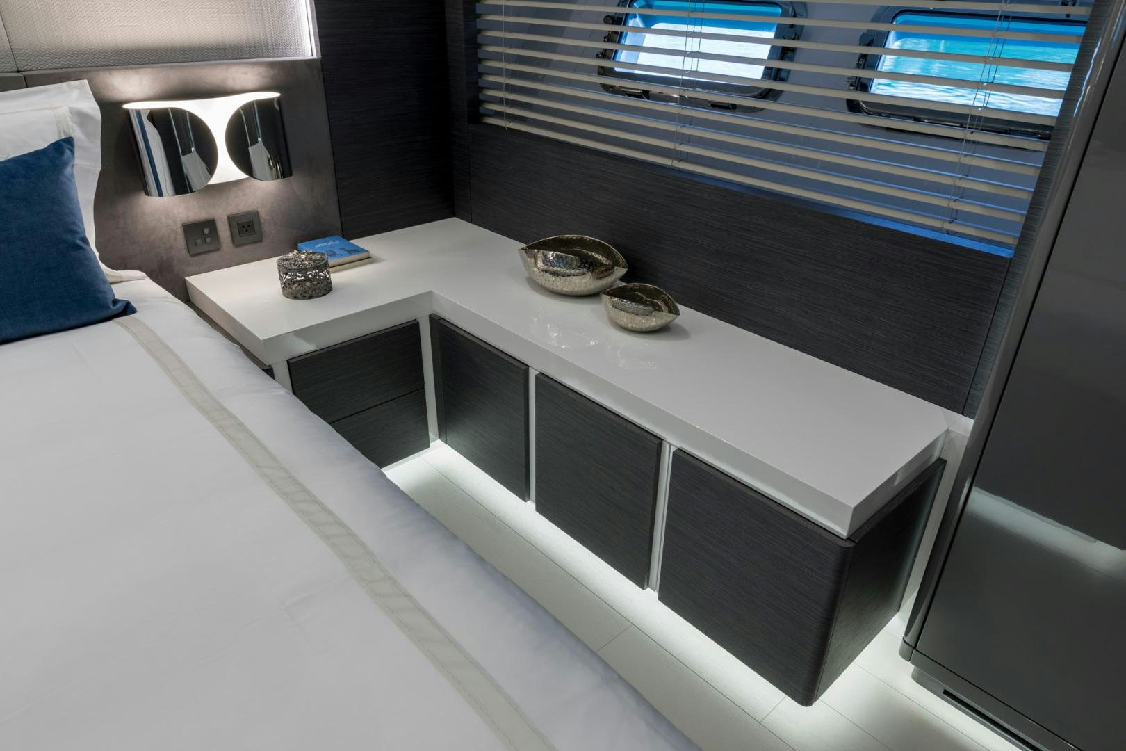 a white table with a silver tray and a coin on it aboard NANA I Yacht for Sale